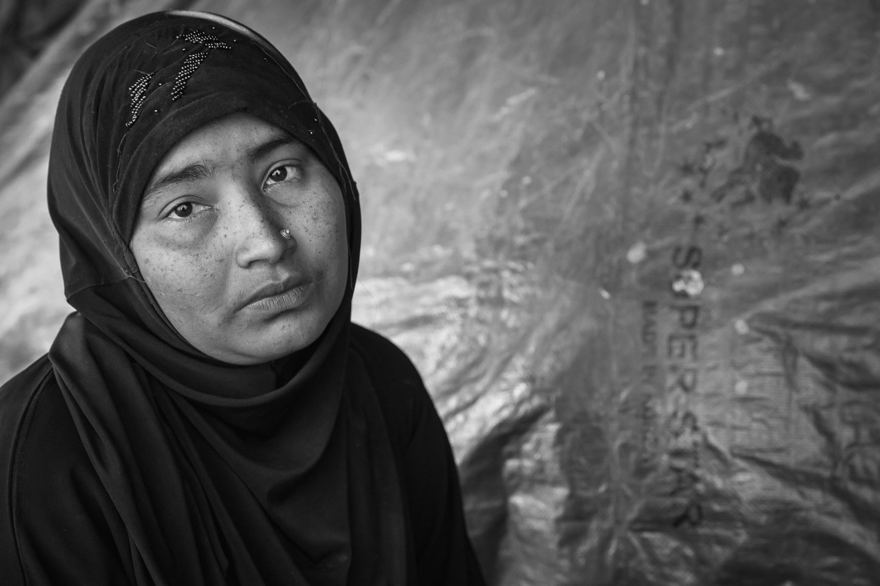 Mosafa, 25 years, from Chut Pyin near Rathedaung. She is one of the numerous rape victims. Her husband was killed by decapitation in front of her. She has four young daughters of 3, 5, 8, and10 years. She was gang-raped for 3 hours by military and local Rakhine residents. After being raped she was left for dead and finally escaped with her children that were left unharmed. She came to Bangadesh by foot with her children and other villagers. Chut Pyin village is one of the numerous Rohingya villages that have been totally wiped out and where severe acts of ethnic cleansing with genocidal intend have been committed by the military and local mobs. Hundreds of Rohingya have been massacred in this village alone. Tangkhali camp, Bangladesh, March 2018