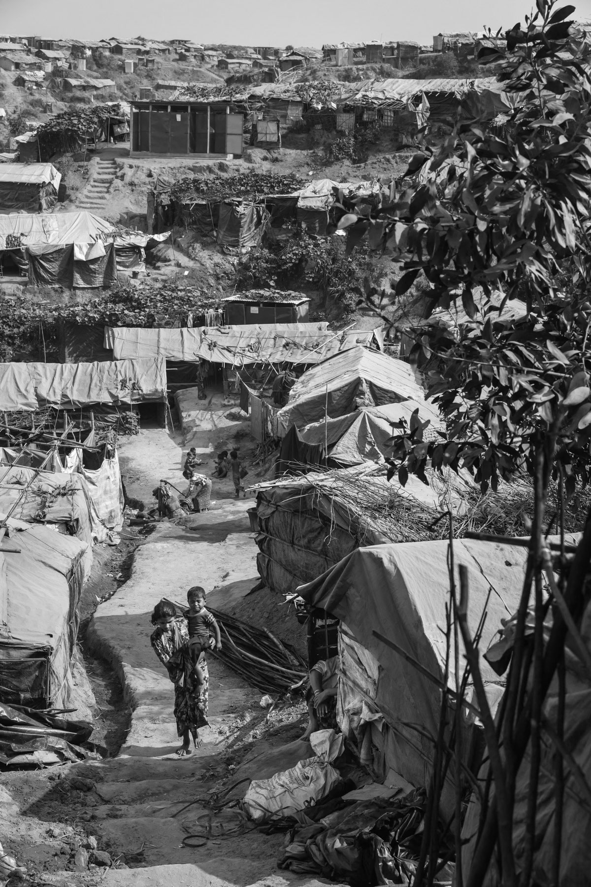 A new extension to the already overcrowded refugee camps to shelter part of the 650,000 newly arrived Rohingya refugees. The Rohingya refugee camps are now sheltering Rohingya victims of the 1978, 1992, 2008, 2012, 2016 and 2017 ethnic cleansing campaigns. By the begining of 2018 more than one million Rohingya refugees live in tha camps near Cox's Bazar making it the largest refugee camps in the world. Thangkhali refugee camp, Ukhiya, Bangladesh, March 2018