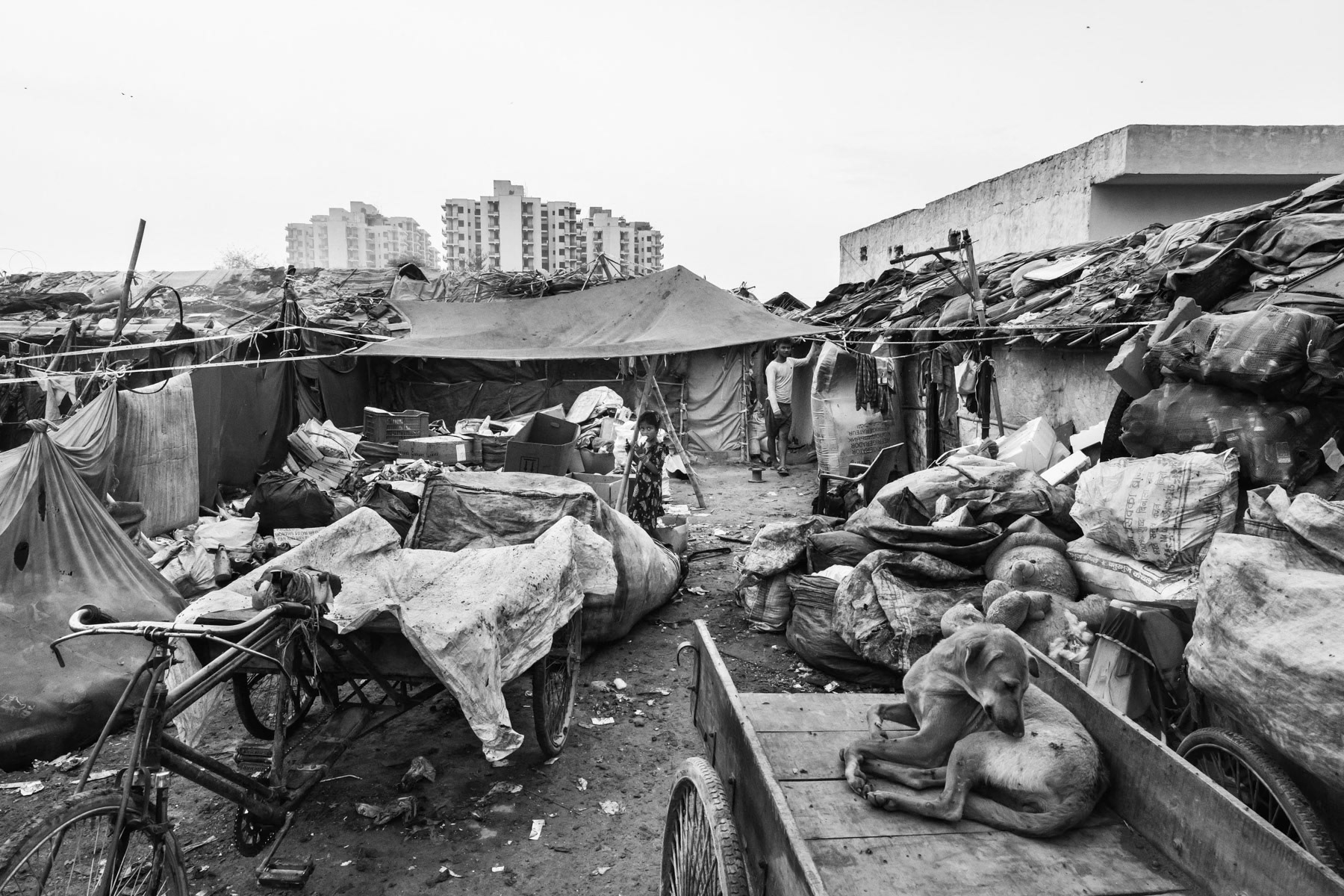 Burana bonded labour camp where 37 Rohingya families are enslaved and "owned" by a local contractor controlling waste picking and recycling in the area. The ones victim of bonded labour are extremely vulnerable and face an almost impossible task to buy themselves out of this situation. Although illigal, bonded labour practices are still widespread and rarely stopped by the authorities. Faridabad in Haryana, India, June 2017