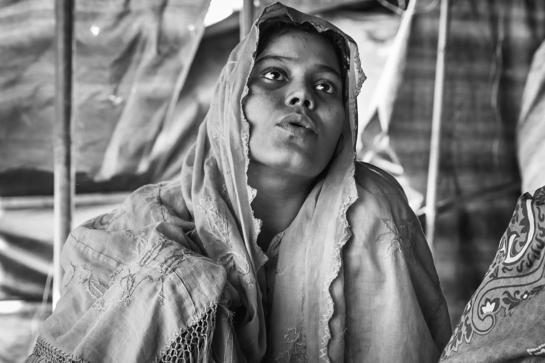 Roiza Khatun, 23 years, from Chut Pyin, Rathedaung. Her husband, daughter and one of her 3 sons were killed when the village was attacked. She was gang-raped in her house with 4 other women by 8 to10 military for a couple of hours. Two of the women died while being raped. They were blindfolded so they would recognize their rapists, and their hands would be tight. She lives now with her mother in law, her two surviving sons. Chut Pyin village is one of the numerous Rohingya villages that have been totally wiped out and where severe acts of ethnic cleansing with genocidal intend have been committed by the military and local mobs. Hundreds of Rohingya have been massacred in this village alone. Tangkhali camp, Bangladesh, March 2018