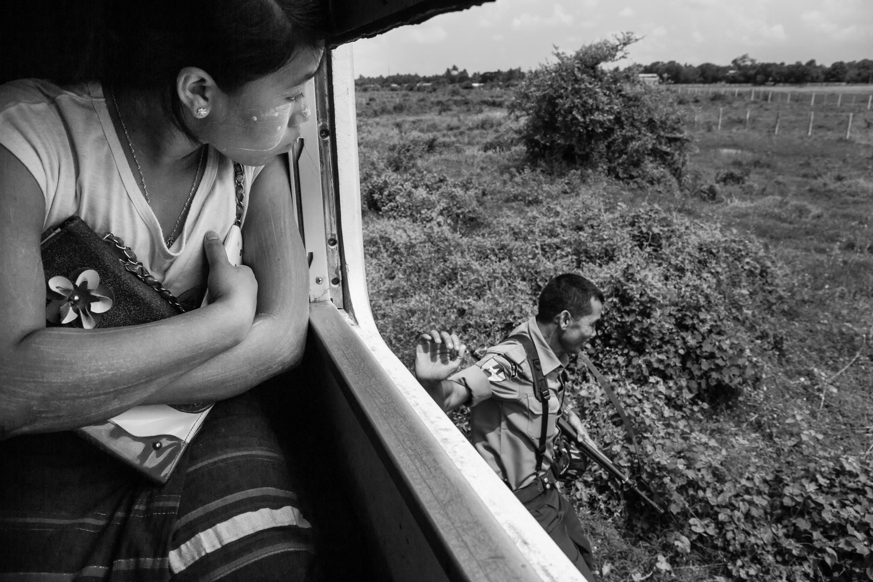The apartheid trein under heavy guard running through the IDP camps outside Sittwe, Rakhine, Myanmar, June 2016