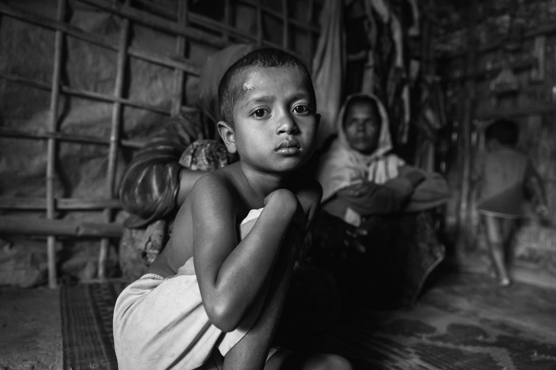 Subiya Khatun's son, one of her surviving children from Chut Pyin near Rathedaung. Subiya is 35 years, her daughter of 15 was raped and consequently killed during the attack on their village by Myanmar military and local Rakhine mobs. Her husband was decapitated and 2 sons of 12 and 13 years were also killed in cold blood. She has one son who fled to Malaysia by boat in 2015 when he was 16 years. She hasn't received any phone call from him since March 2017 and has lost all track of him. Subiya is living with her 4 surviving young children in Bangladesh since Septamber 2017. Thangkhali Rohingya refugee camp in Bangladesh, October 2018