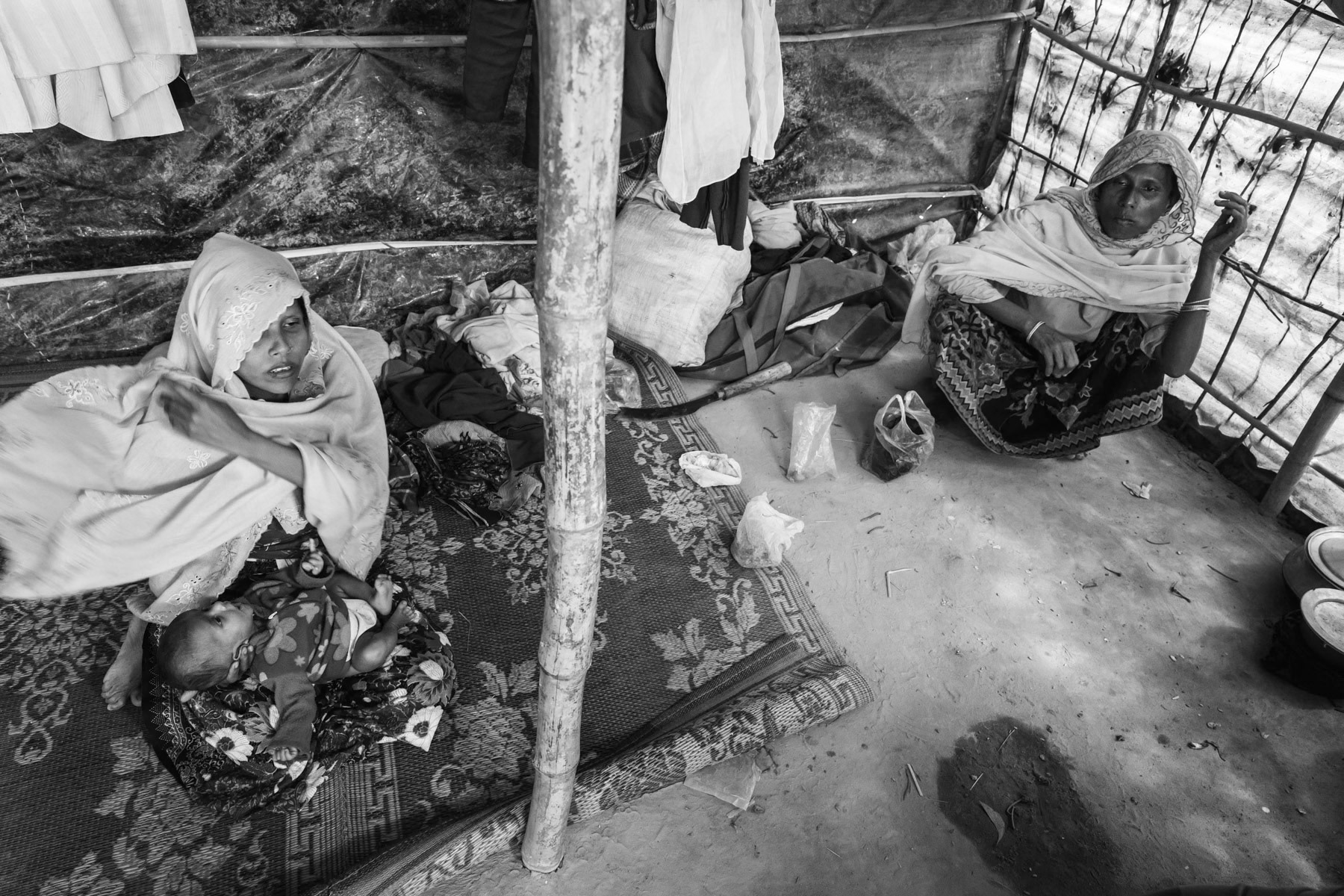 Rape victim with her 2 month old baby and mother in law. She was gang-raped by 4 soldiers one week after giving birth and after her husband was killed. Fled 3 weeks ago from their village in northern Maungdaw township accross the border in Myanmar. Bulukhali camp for recently arrived persecuted Rohingya from Myanmar, Cox's Bazar, Bangladesh, February 2017