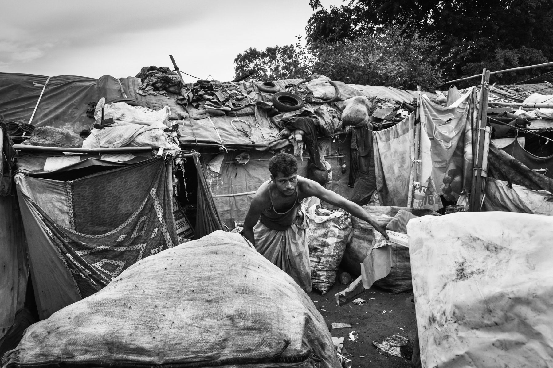 Burana bonded labour camp where 37 Rohingya families are enslaved and "owned" by a local contractor controlling waste picking and recycling in the area. The ones victim of bonded labour are extremely vulnerable and face an almost impossible task to buy themselves out of this situation. Although illigal, bonded labour practices are still widespread and rarely stopped by the authorities. Faridabad in Haryana, India, June 2017