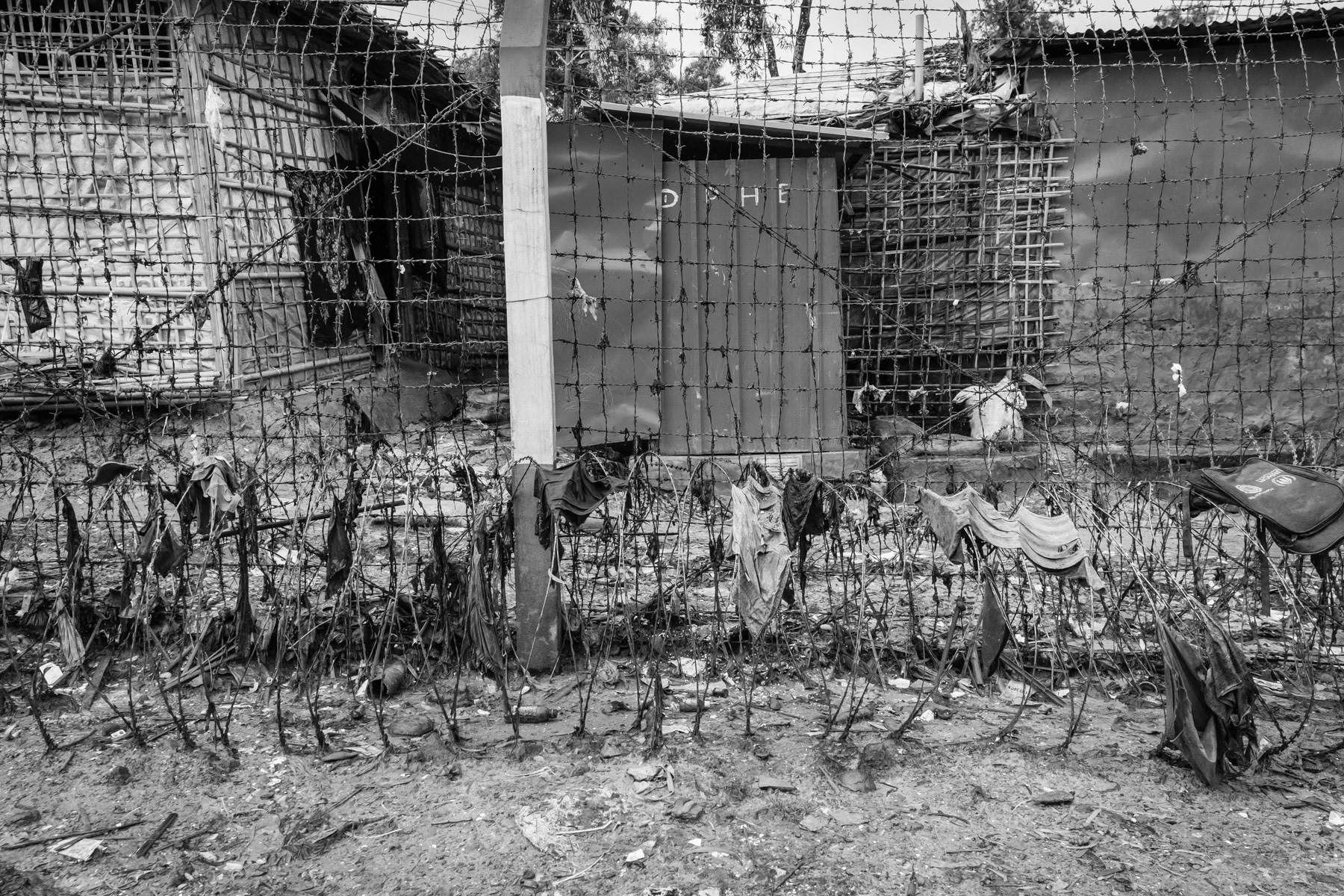 Fences, barbed wire and watch towers are surrounding the refugee camps making it very hard to reach clinics, stores and commodities located outside the camps. After living for more than 5 years in limbo it is very unreal to see any perspective of returning to their homeland or being re-settled in a third country for the growing population of over one million Rohingya refugees. Kutupalong refugee camp, Cox's Bazar, Bangladesh, September 2022