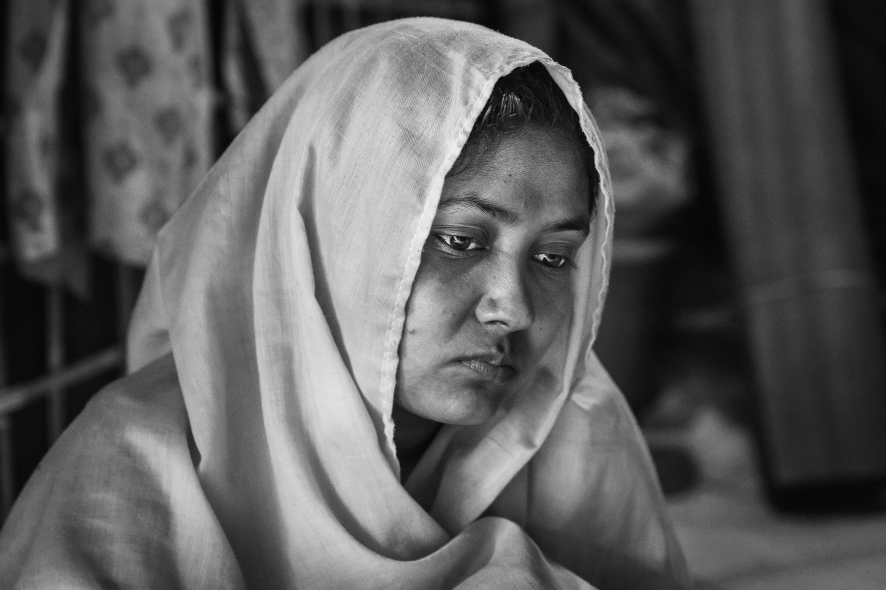 Shopika Begum, 20 years from Tula Tuli in Maungdaw township in Myanmar. She was gang raped by the military forces that attacked the village on 30 August 2017. Shopika's husband was executed and decapitated, she was taken with approximately 30 other women to barracks where they would be repeatedly gang raped by groups of 5-6 military. After the gang rapes the women would be assaulted with machette, left for dead and burned in the barracks. Very few survived, only those that had still the strenght to escape through the back and the fields. It took her 5 days to reach Bangladesh. She was reunited with her sister once in Bangladesh. There have been countless witnesses of atrocities by the Burmese regime and its military forces. Human rights commissions and international groups have called the ongoing onslaught a schoolbook case of ethnic cleansing evoloving into a genocide of the Rohingya community in Rakhine. Widespread gang rapes have been widely documented through testimonies of the survivors in the camps. Balukhali camp for Rohingya refugees in Bangladesh, November 2017