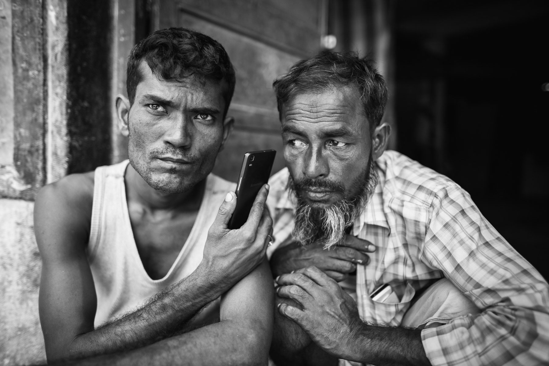 Rohingya refugees listening to the news of ongoing ethnic cleansing campaigns back home in Myanmar. They fled in 2012 and found shelter ans safety in India. Kelembakkam in the State of Tamil Nadu, June 2017