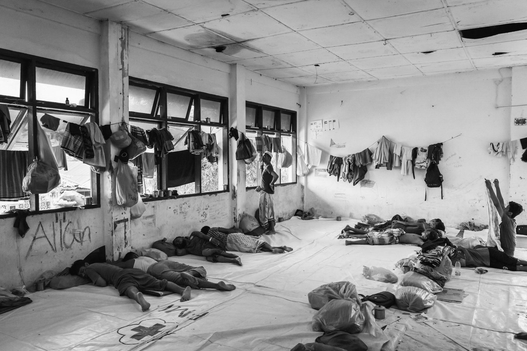 Rohingya in a refugee centre. They have recently arrived by boat from Bangladesh, a journey that takes several weeks in overcrowded wooden boats. The Rohingya flee persecution and conflict in Myanmar. The Aceh region on the island of Sumatra in Indonesia is seen by many as a safe place from where they may have better opportunities and safety than in the refugee camps in Bangladesh. Lhokseumawe refugee center, Aceh, Indonesia, February 2024