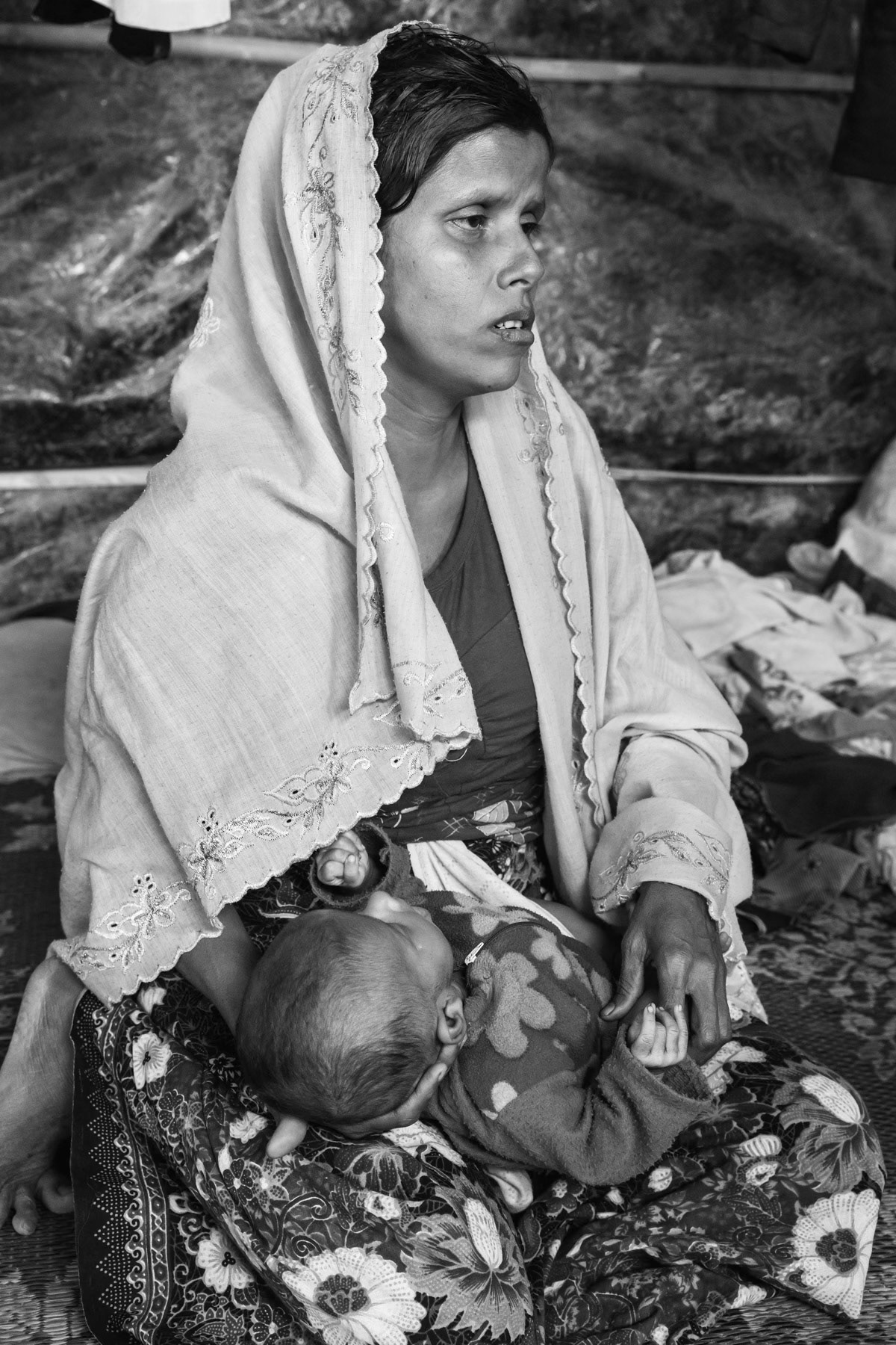 Rape victim with her 2 month old baby and mother in law. She was gang-raped by 4 soldiers one week after giving birth and after her husband was killed. Fled 3 weeks ago from their village in northern Maungdaw township accross the border in Myanmar. Bulukhali camp for recently arrived persecuted Rohingya from Myanmar, Cox's Bazar, Bangladesh, February 2017