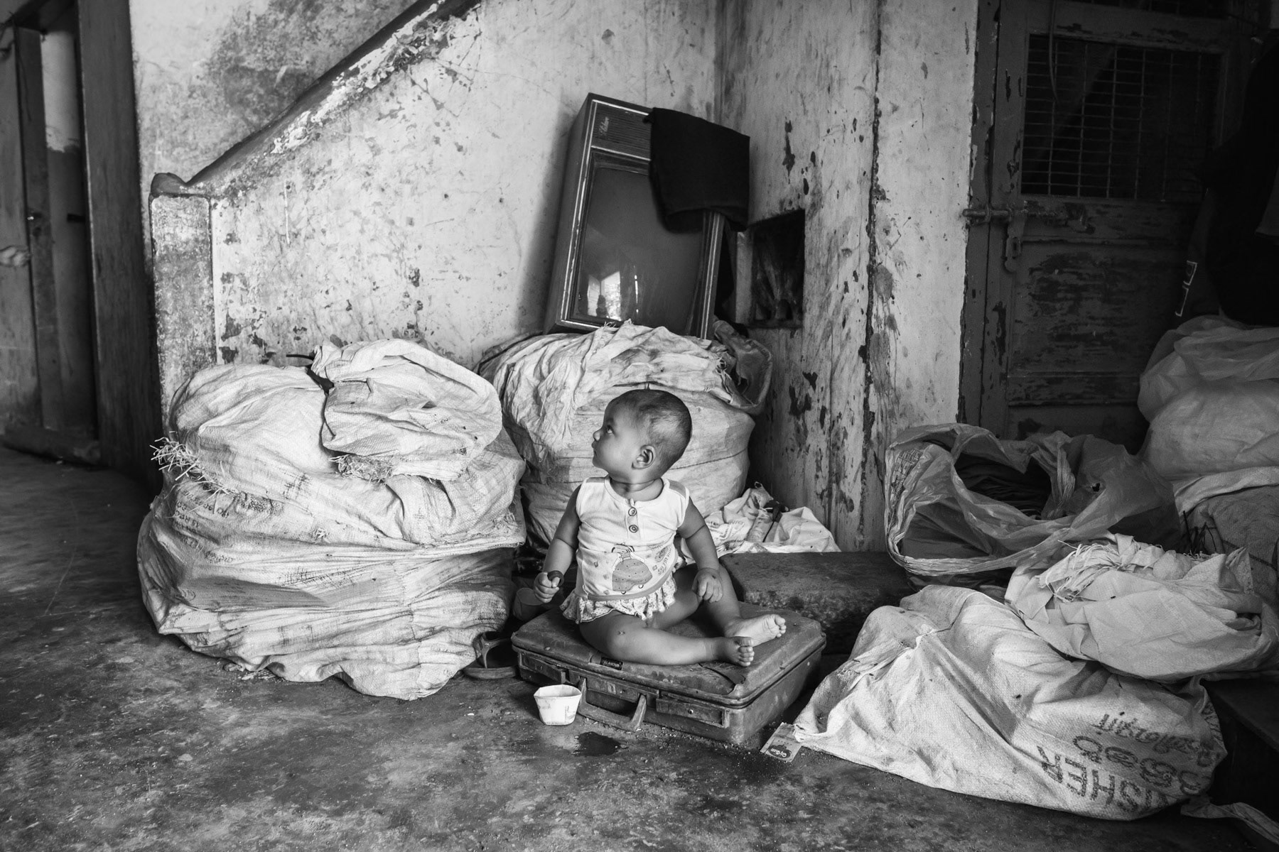 A Rohingya toddler living with her family in a decommissioned cyclone shelter after having fled from Myanmar in 2012. Kelembakkam near Chennai in Tamil Nadu State, India, June 2017