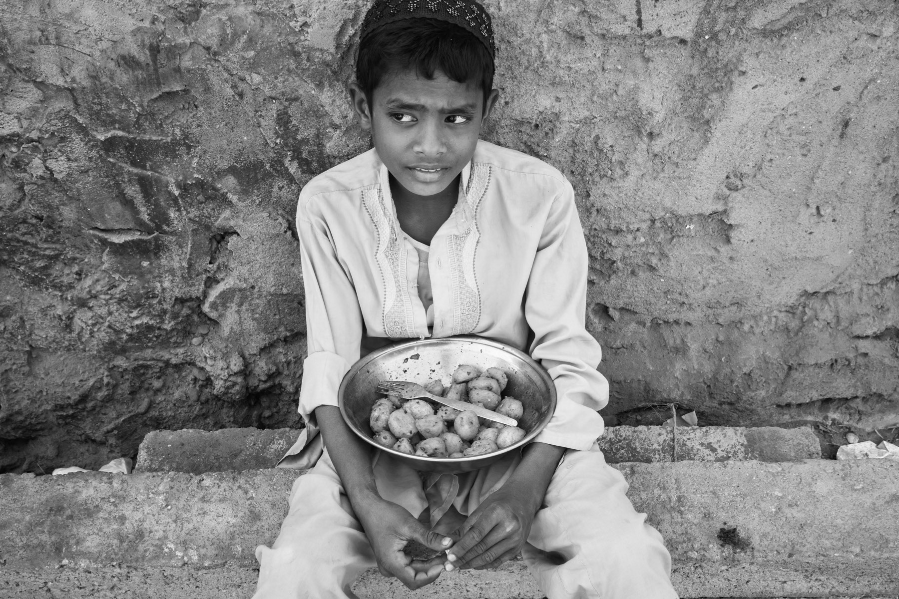 Boy selling street food, Rohingya area of Arkanabad, Karachi, Pakistan, March 2018