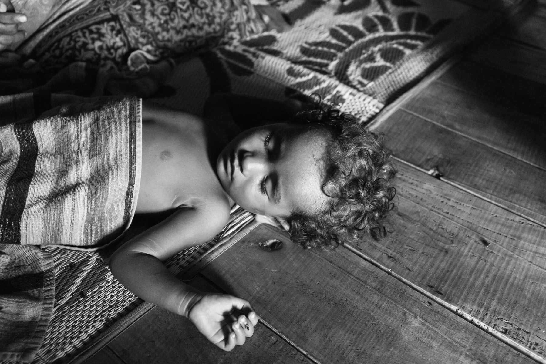 Child sleeping, Mewat camps for stateless Rohingya from Burma. Nagli Nuh, Haryana, India, June 2016