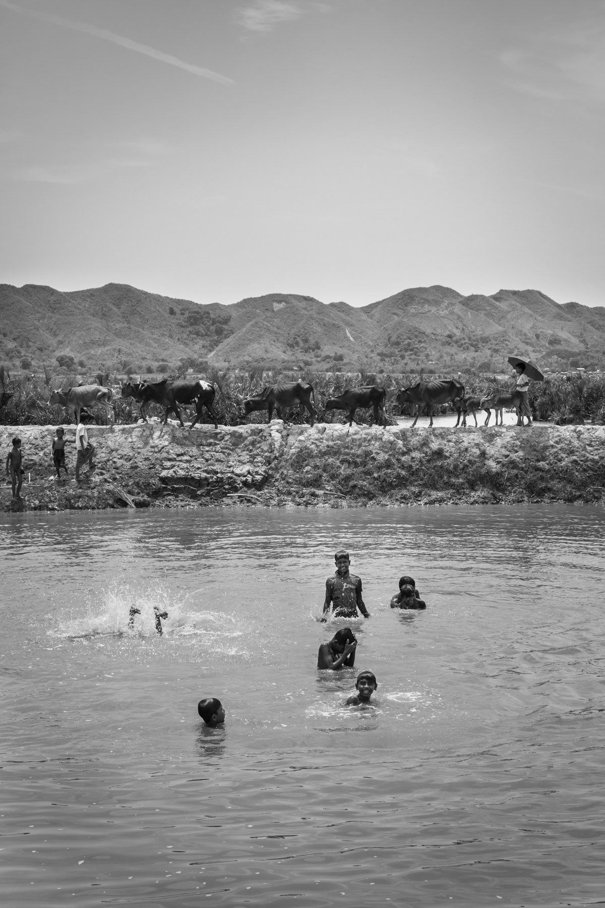 Rohingya children refreshing themselves in the river, Kyin Ni Pyin IDP Camp near Paktauw in Rakhine, Myanmar, May 2017