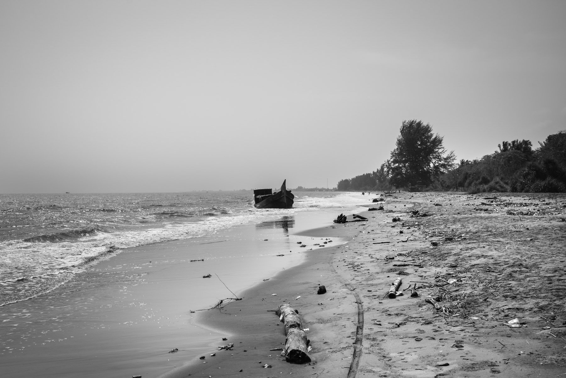 A boat used by Rohingya refugees to flee from Myanmar. The Rohingya have been persecuted for many years in their homeland making them flee for safety and survival to Bangladesh, Malaysia and now Indonesia as boat people spending several weeks at sea on unworthy boats at the peril of their lives. Pidie shore, temporary shelter, Aceh, Indonesia, February 2024