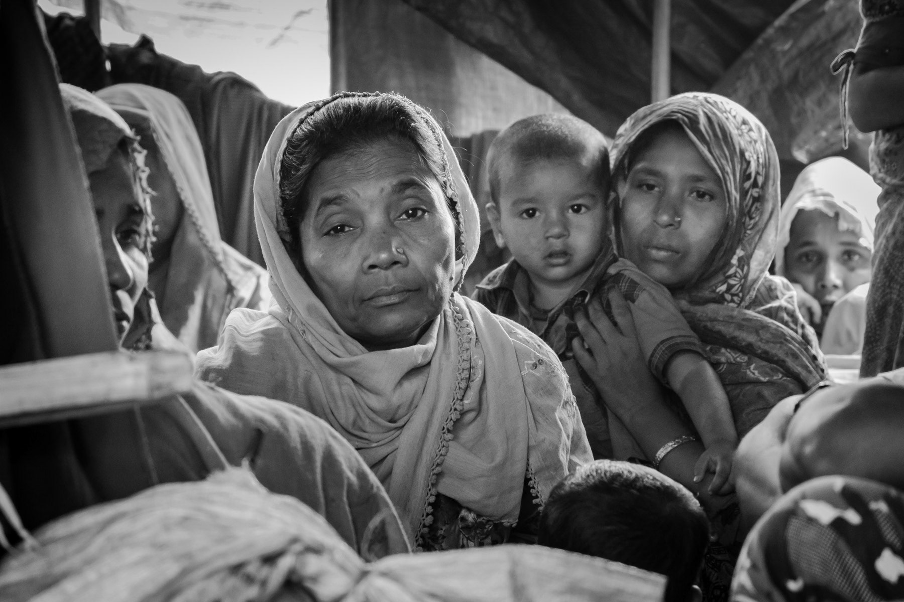 Survivors of the Chut Pyin massacre and victims of extreme sexual violence, waiting to testify of what happened in their village on 27 August 2017. Chut Pyin village is one of the numerous Rohingya villages that have been totally wiped out and where severe acts of ethnic cleansing with genocidal intend have been committed by the military and local Rakhine mobs. Hundreds of Rohingya have been massacred and dozens of women have been gang-raped in this village alone. Tangkhali camp, Bangladesh, March 2018