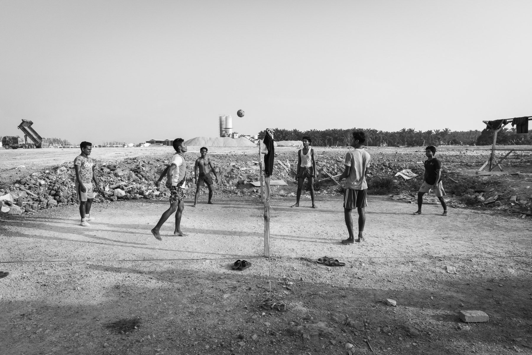 Rohingya construction workers relaxing and playing a foot/volley-ball game after work. Desa Ku construction site, Kedai, Malaysia, June 2017