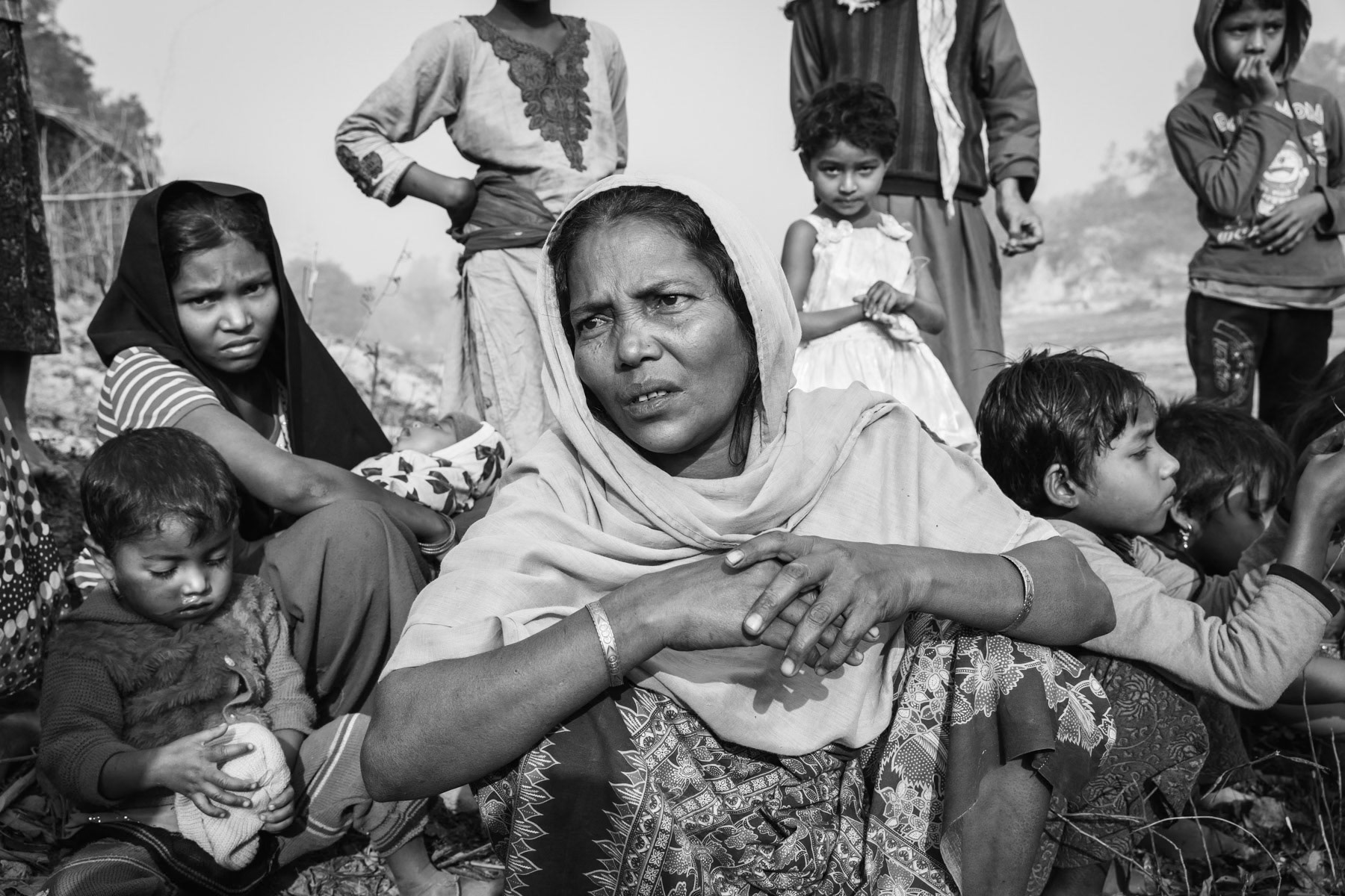 Rohingya refugees that arrived 7 days ago from Myanmar. They have no shelter yet, and sleep at other refugee's shelters and sit outside during the day. Balulkali camp still receiving an average of 100 refugees per day. Bangladesh, February 2017