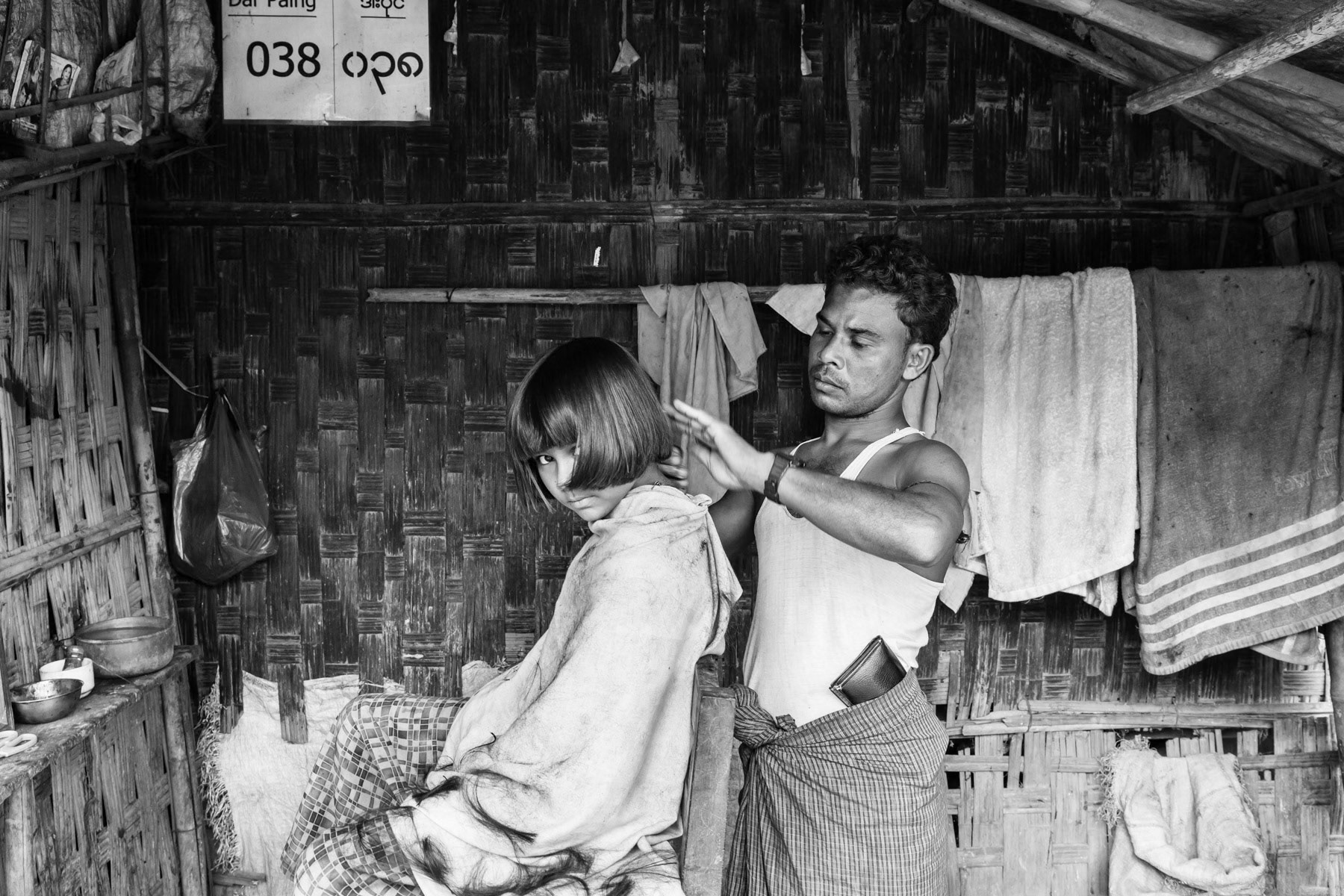 Rohingya girl at the hairdresser in Dar Paing camp for internal displaced persons, Sittwe township, Myanmar, September 2015