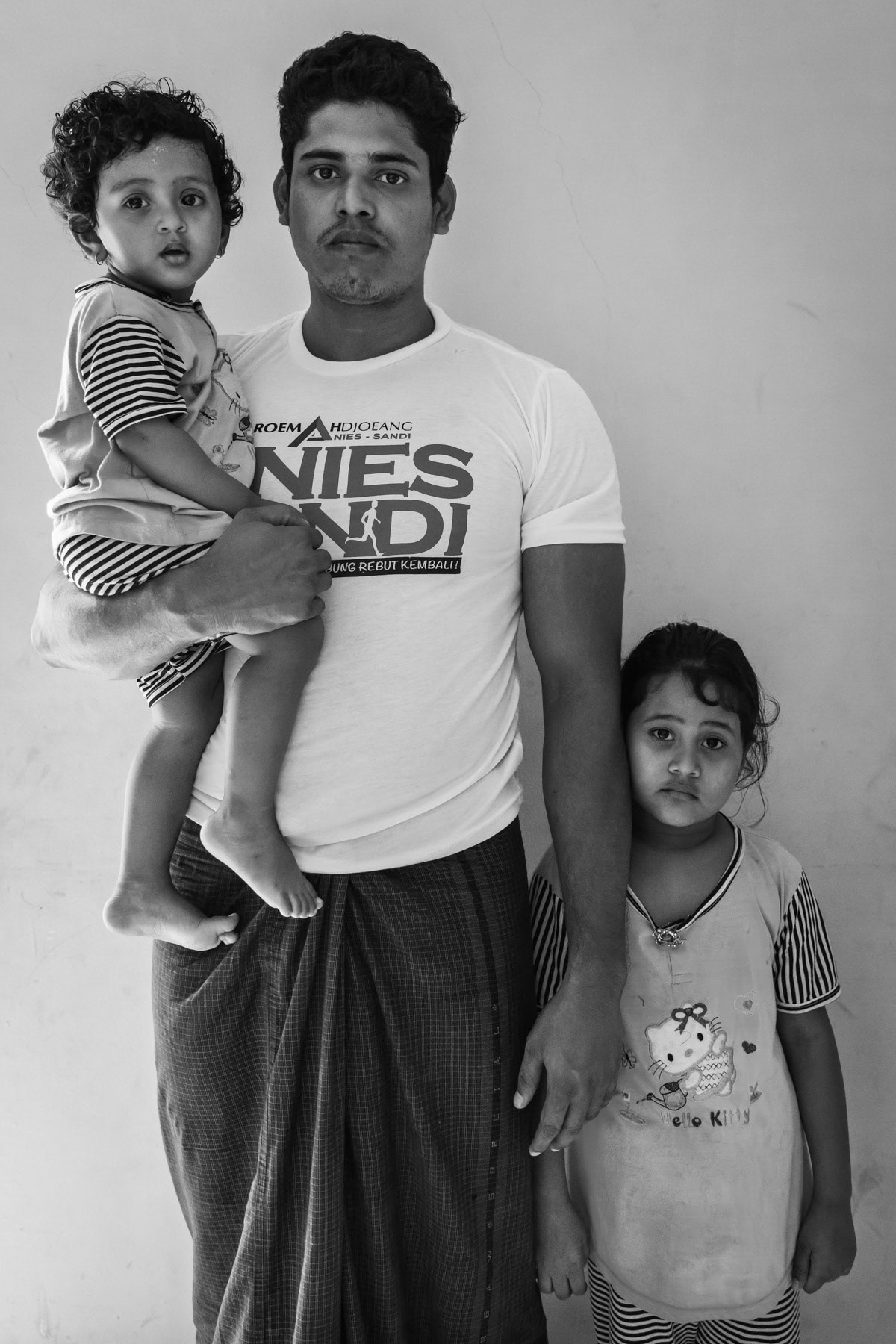 A Rohingya refugee from Myanmar and his two daughters few days before being re-settled in Kansas, USA. Refugee centre in Jakarta, Indonesia, January 2017