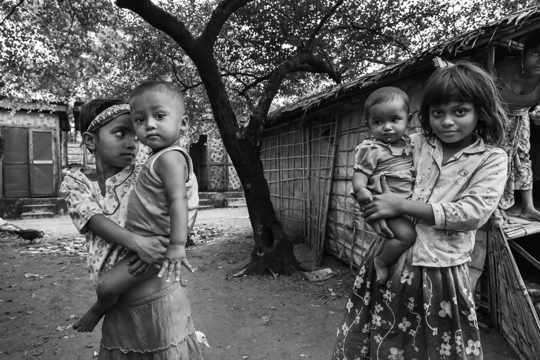 Rohingya children caring for their siblings. Thau Chaung camp for forcibly displaced Rohingya, Sittwe in Rakhine State of Myanmar, October 2016