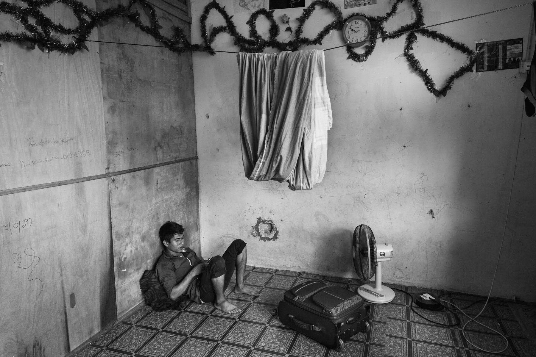 Rohingya man recently arrived in Malaysia where better job opportunities may facilitate family reunion and eventual migration towards a western third country. Wholesale market housing in Klang Valley, Malaysia. June 2016