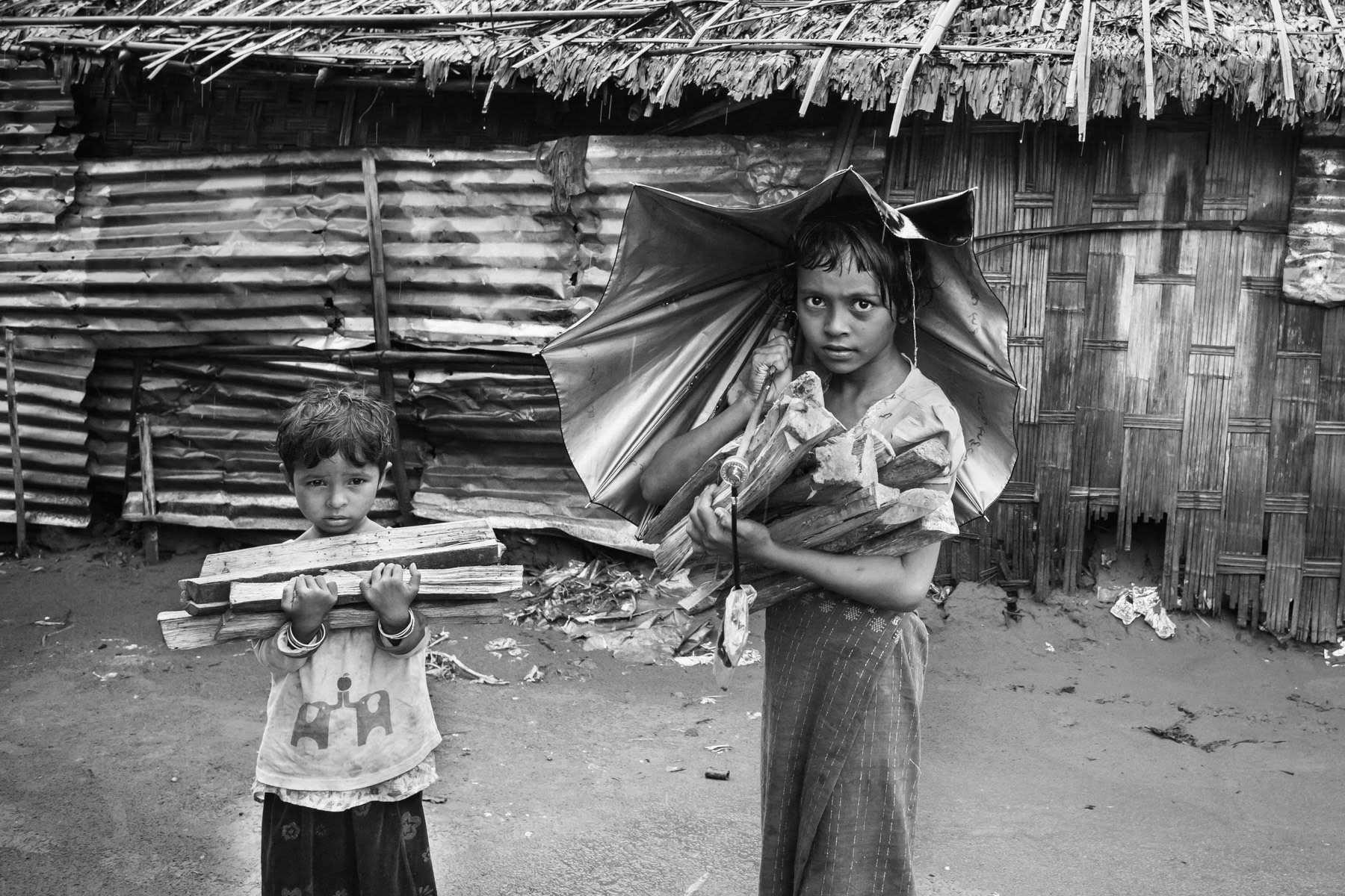 Rohingya children getting fire wood for cooking. Baw Du Pha internment camp, Sittwe township, Myanmar, October 2016