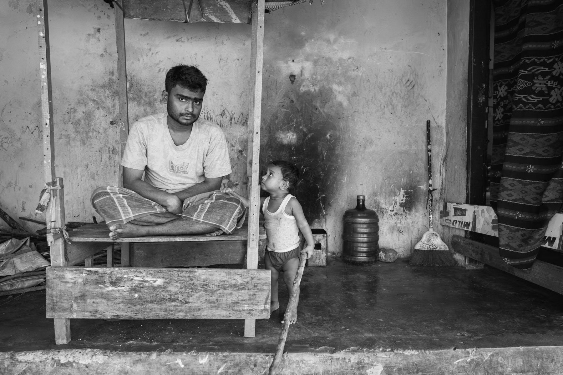 Father and son staying in a shelter for Rohingya boat people that arrived on the coast of Aceh between December 2022 and April 2023. Padang Tijie, Bandar Aceh, Indonesia, October 2023