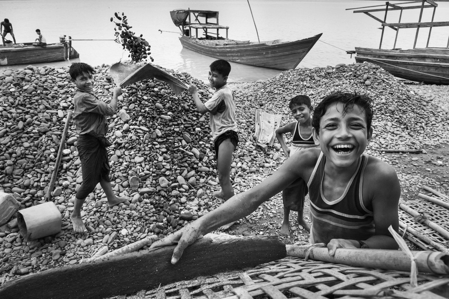 Rohingya children sorting river extracted stones used for the condtruction of a nearby airport. Nam-Kya village near Mrauk-Oo, Rakhine, Myanmar, May 2016