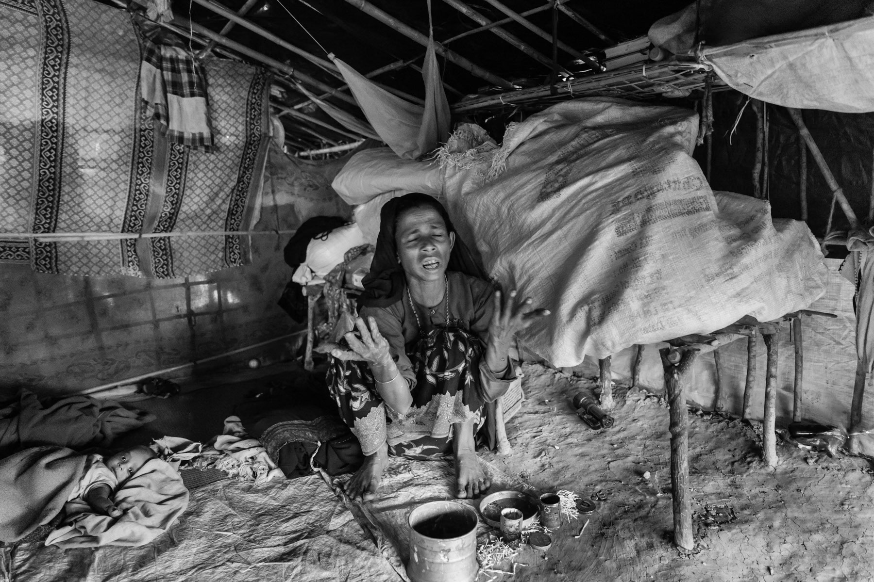Rehana Begum's forty years old mother. She fled to Bangladesh from Rathedaung in Myanmar with her daughter and mother, and grand children nearly 3 months ago. Her daughter was gang raped by the Myanmar military for 5 days while she was pregnant. Her son in law was killed, decapitated and burnt in front of them when the village was attacked and entirely burnt down in August 2017. Lambashiya section of Kutupalong camp in Ukhiya, Bangladesh, November 2017