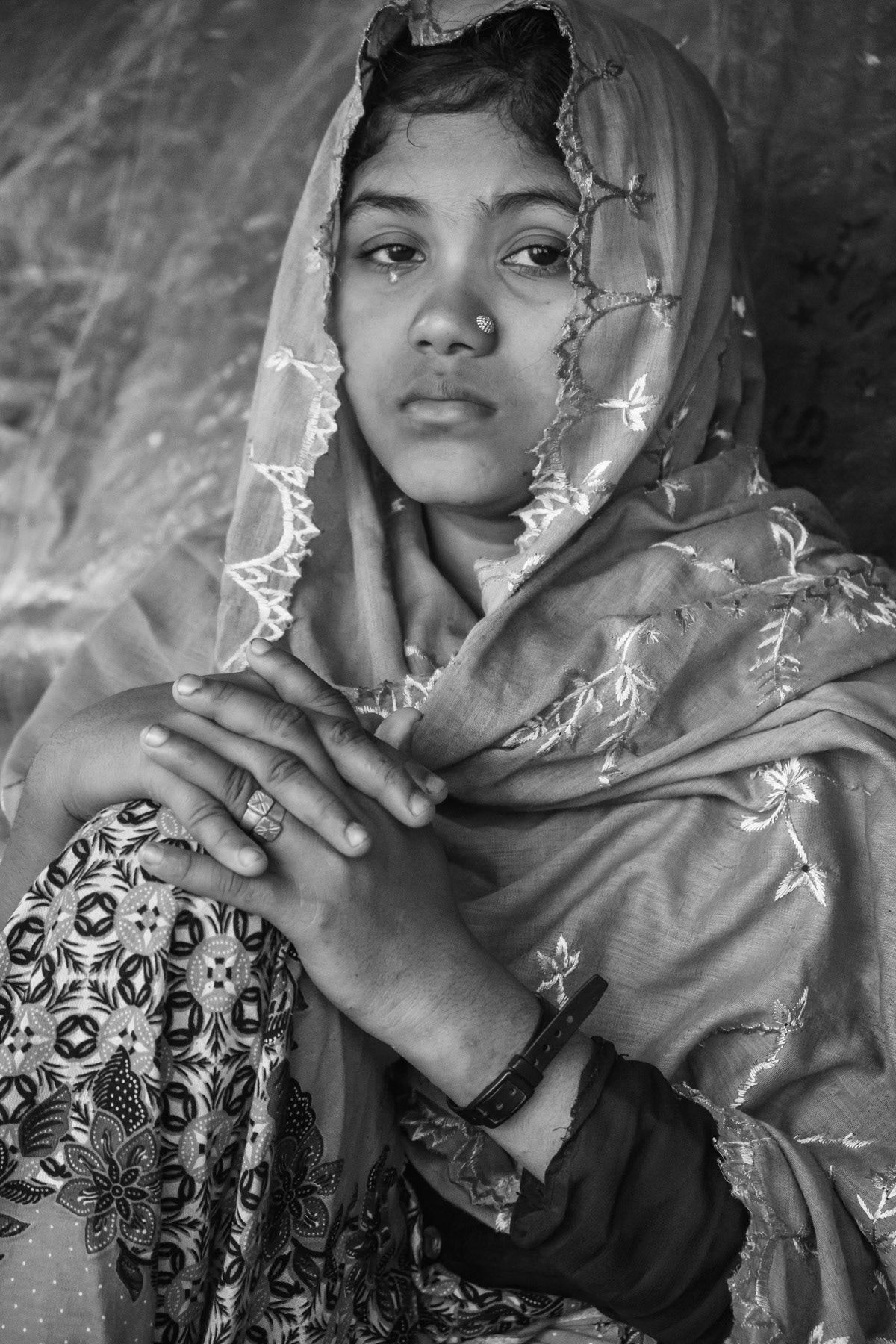Sufayra Begun, 20 years, from Chut Pyin, Rathedaung. Got married one month before the attack in August 2017. Her husband was shot and killed, along with her father in law and brother by the military. Together with other women and girls she was taken blindfolded and tight to a shed where they would be gang-raped by the military and local rakhine mobs for several hours. Few of them were killed while being abused. Together with eight other women she managed to escape and returned near the village to find family that had survived the massacres. Although she was blindfolded she has recognized the voices of the non-military rapists, all were local Rakhine from the same village. It took her nearly a week to reach Bangladesh in September 2017. She now lives alone with her 4 year old sister, her mother lives in another block of the camp. Chut Pyin village is one of the numerous Rohingya villages that have been totally wiped out and where severe acts of ethnic cleansing with genocidal intend have been committed by the military and local mobs. Hundreds of Rohingya have been massacred in this village alone. Tangkhali camp, Bangladesh, March 2018