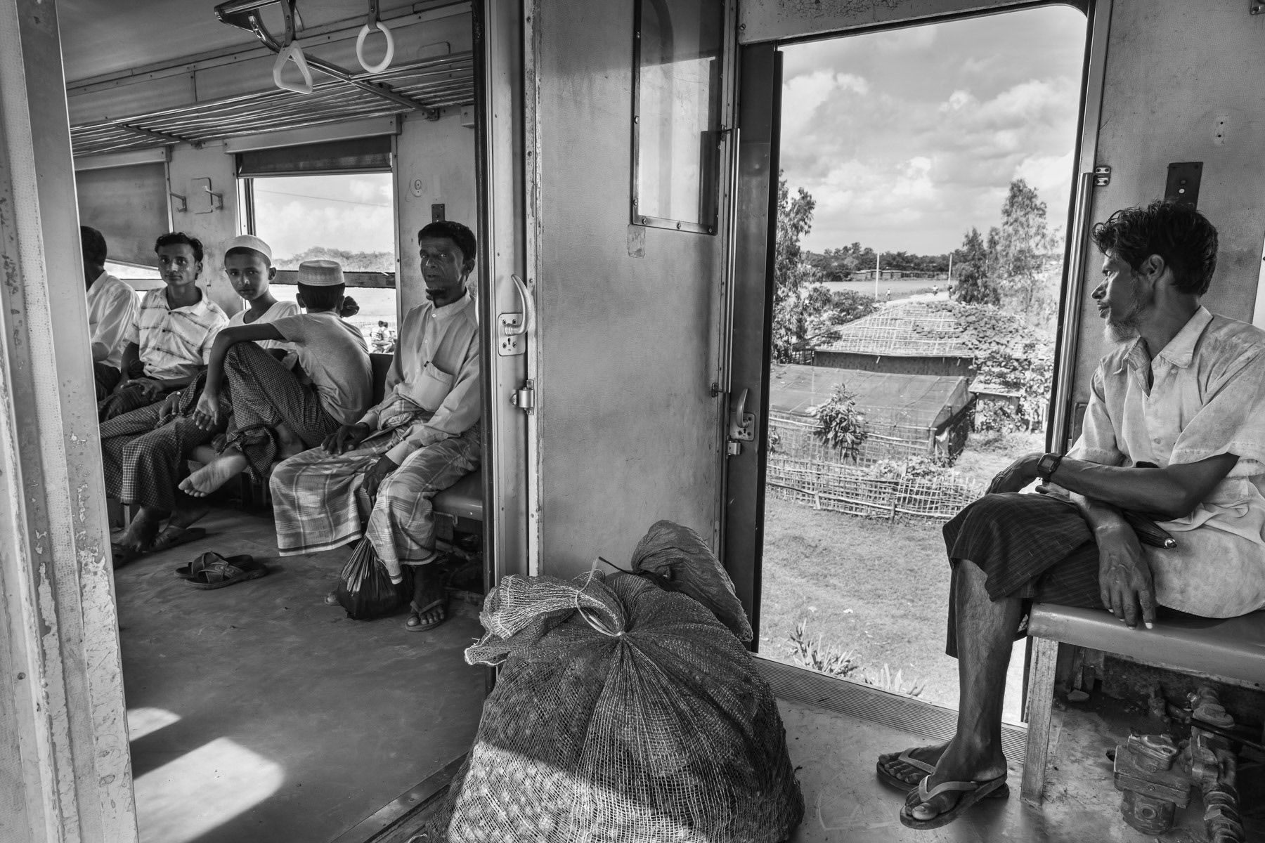 Rohingya minority travelling on the local train between the IDP camps. They are not allowed to travel to Sittwe and the trains are guarded by heavily armed police forces. Sittwe township, Myanmar, September 2019