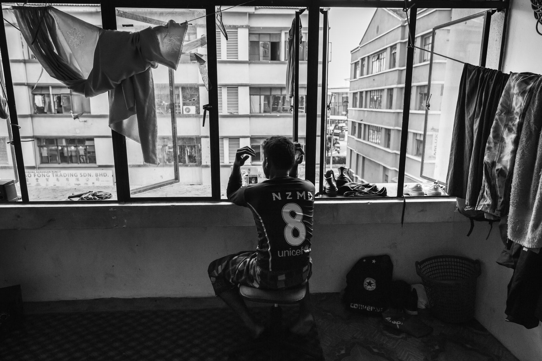 A Rohingya refugee communicating with family back home in Myanmar. Klang Valley, Malaysia, June 2016