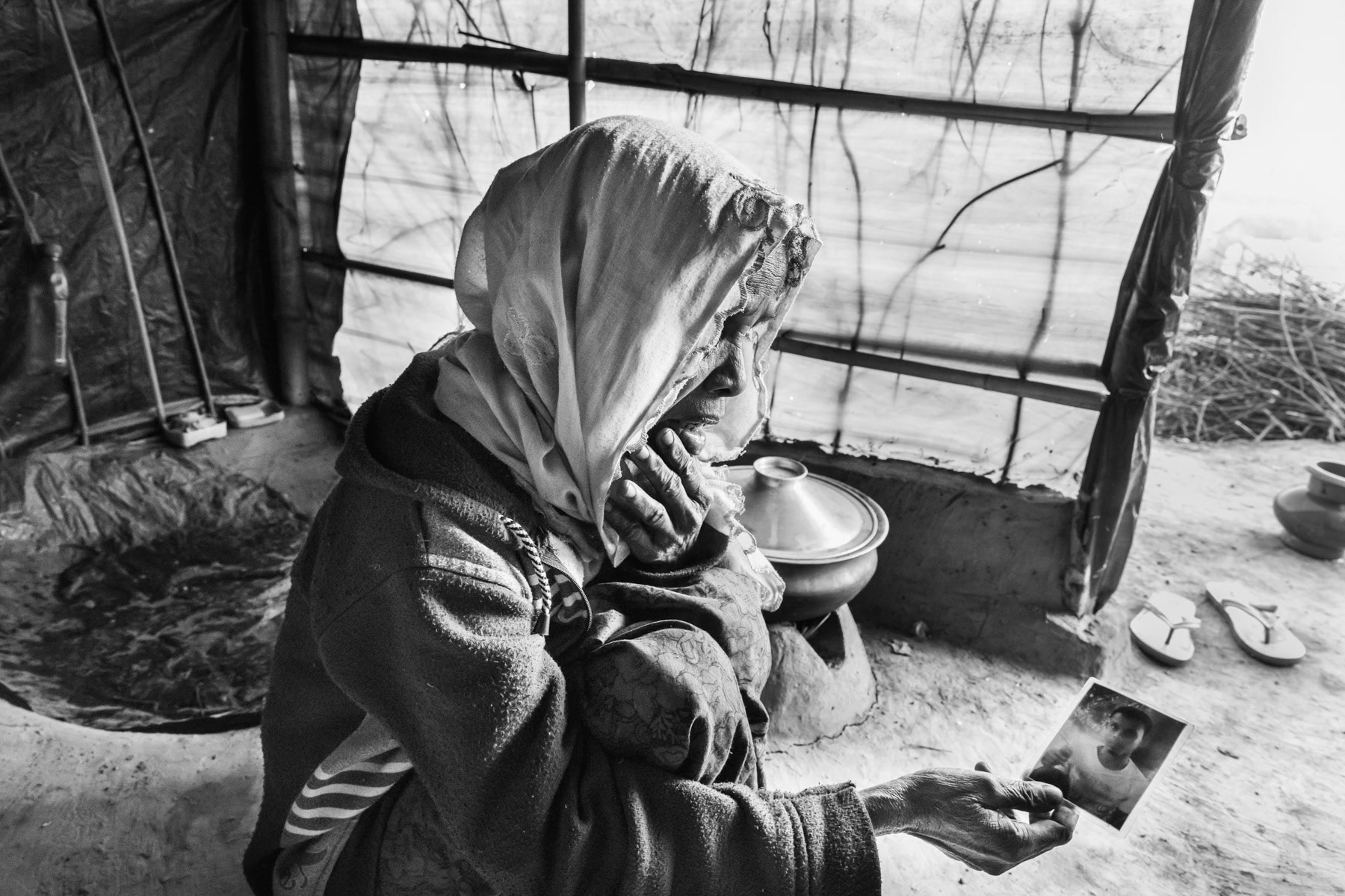 A mother hoping to have news from her son who was takien away by the military in October 2016 during the security sweeps in the northern Rakhine State of Myanmar. Kutupalong refugee camp for Rohingya in Bangladesh, February 2017