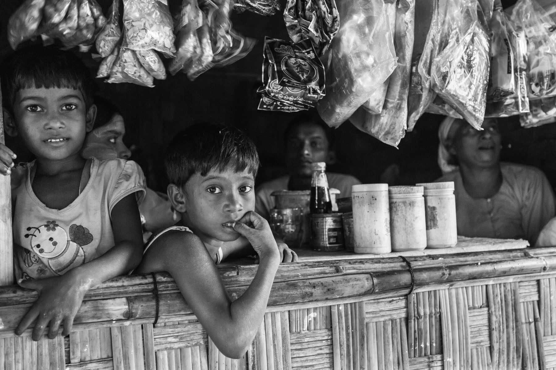 Small grocery shop. Having had their land confiscated, there are no possibilities to grow food in the camps. Food is scarce and double the price than in the market of Sittwe, where the camp population is not allowed to go. Malnutrition is widespread and the general health condition very poor. Baw Du Pha internment camp for the forcibly displaced Rohingya population. Sittwe township, Myanmar, October 2016