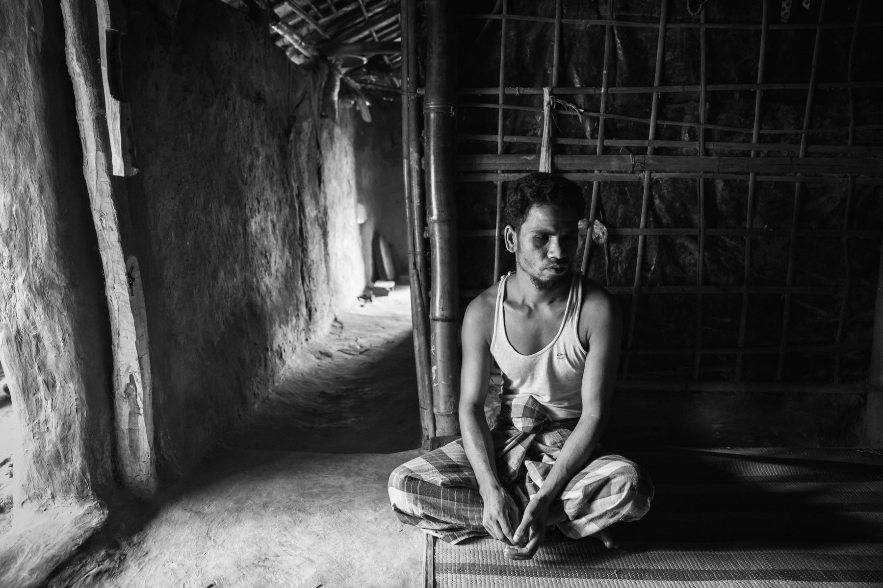Md. Sultan, 30 years from Maungdaw in Myanmar. His village was attacked by the Myanmar military using mortar shells. He was hit by shrapnel that went through his head behind the eyes. He is now blind and needs 24 hours assistance. His brother died during the same mortar attack. It took him 3 days, with the help of his wife and 2 children, to reach Bangladesh. Kutupalong Rohingya refugee camp, Bangladesh, October 2018