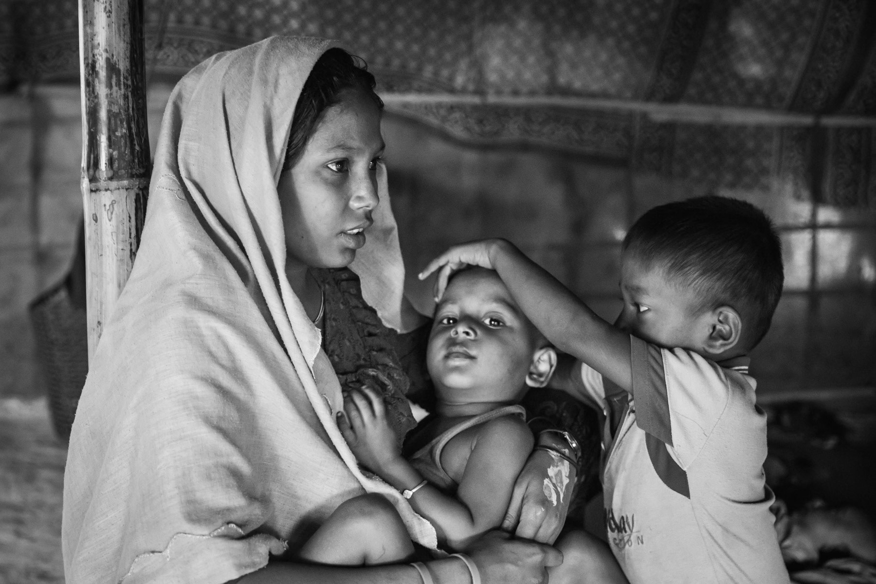 Rehana Begum from Rathedaung in Myanmar is 25 years old and has 3 sons, the youngest being 1 month old only. She fled to Bangladesh with her mother, grandmother and children nearly 3 months ago. She was gang raped by the Myanmar military for 5 days while she was pregnant. Her husband was killed, decapitated and burnt in front of them when the village was attacked and entirely burnt down in August 2017. Lambashiya section of Kutupalong camp in Ukhiya, Bangladesh, November 2017