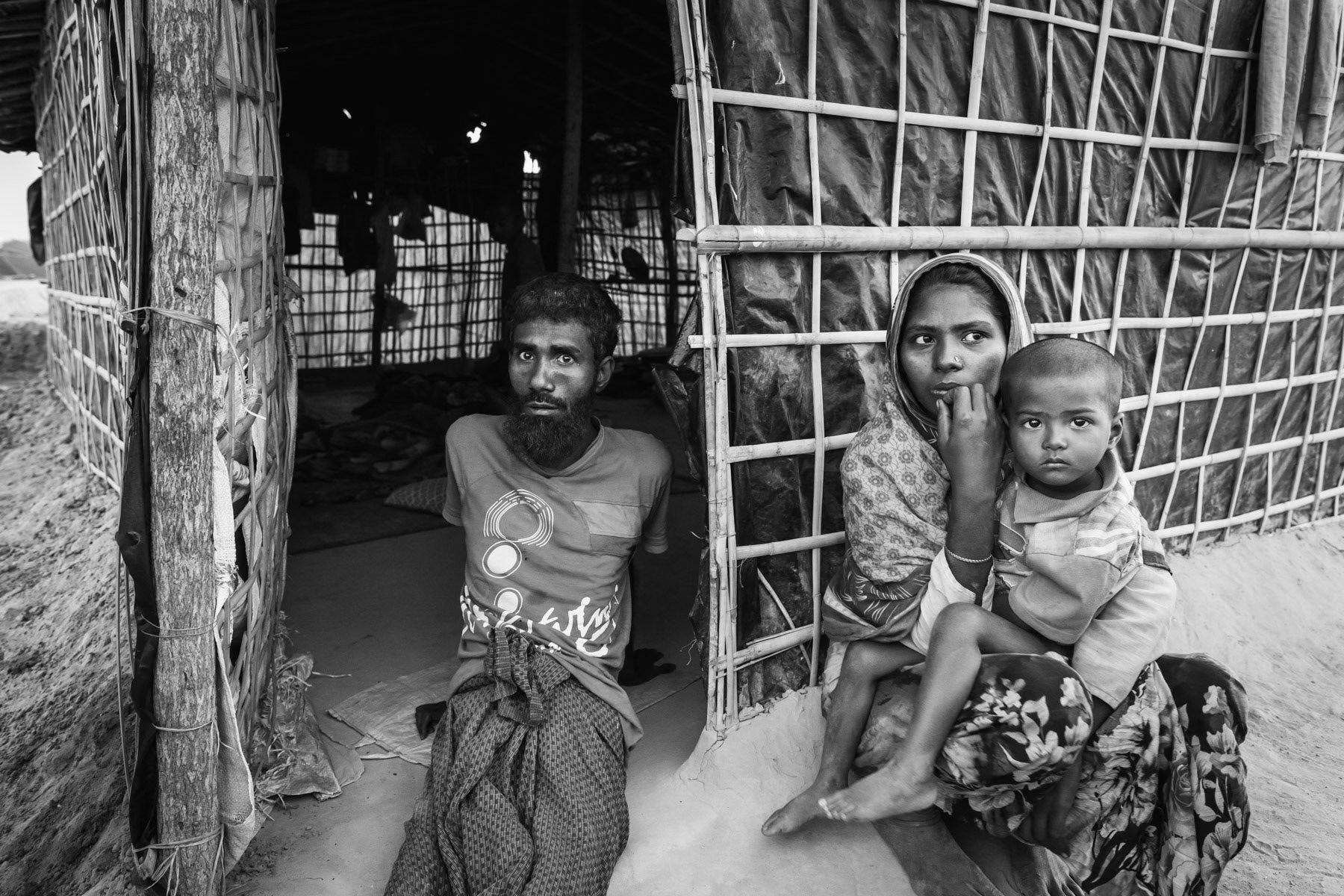 A Rohingya refugee that has recently arrived in Bangladesh with his wife and 5 children. He was an Imam in Myanmar and was tortured in November by the army for days after his legs were broken with metal bars. He was carried into the country. Kutupalong new refugee camp, Cox's Bazar district, Bangladesh, February 2017