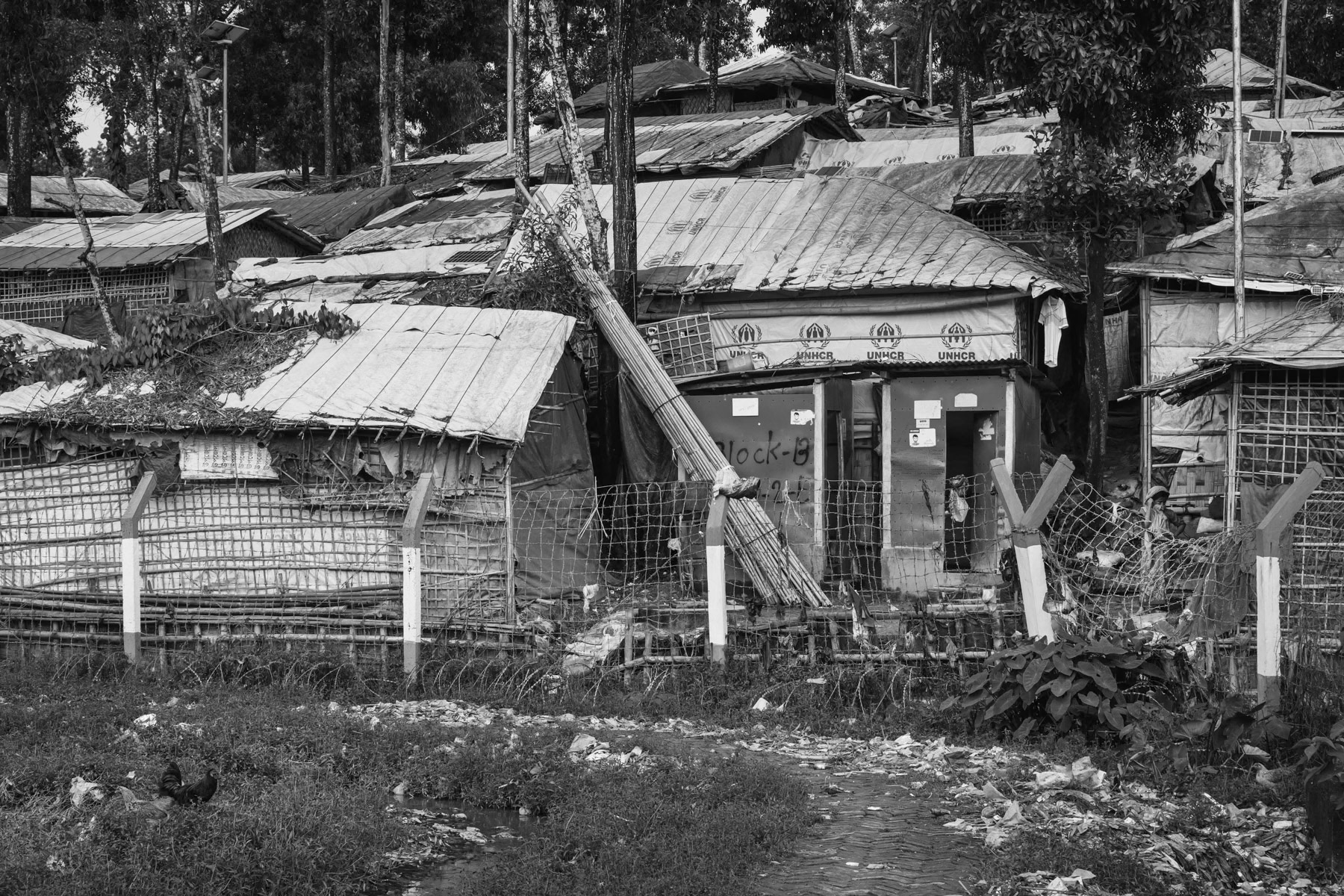 Fences, barbed wire and watch towers are surrounding the refugee camps making it very hard to reach clinics, stores and commodities located outside the camps. After living for more than 5 years in limbo it is very unreal to see any perspective of returning to their homeland or being re-settled in a third country for the growing population of over one million Rohingya refugees. Kutupalong refugee camp, Cox's Bazar, Bangladesh, September 2022