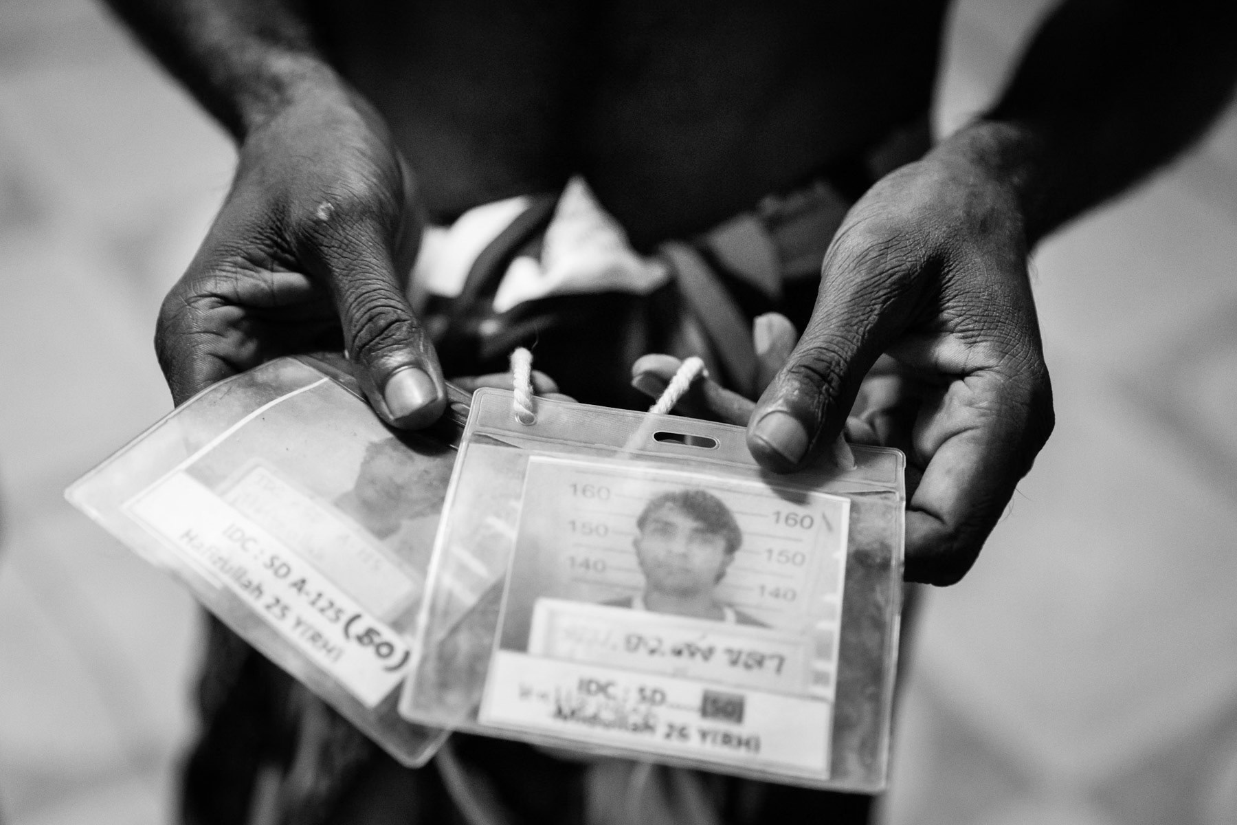 Rohingya refugee recently released from 2 years detention on immigration charges for entering Thailand illegally, showing his and his brother's detention cards. They remain to date illegally in Thailand and face every day the risk of being arrested. Songkhla, Thailand, May 2017