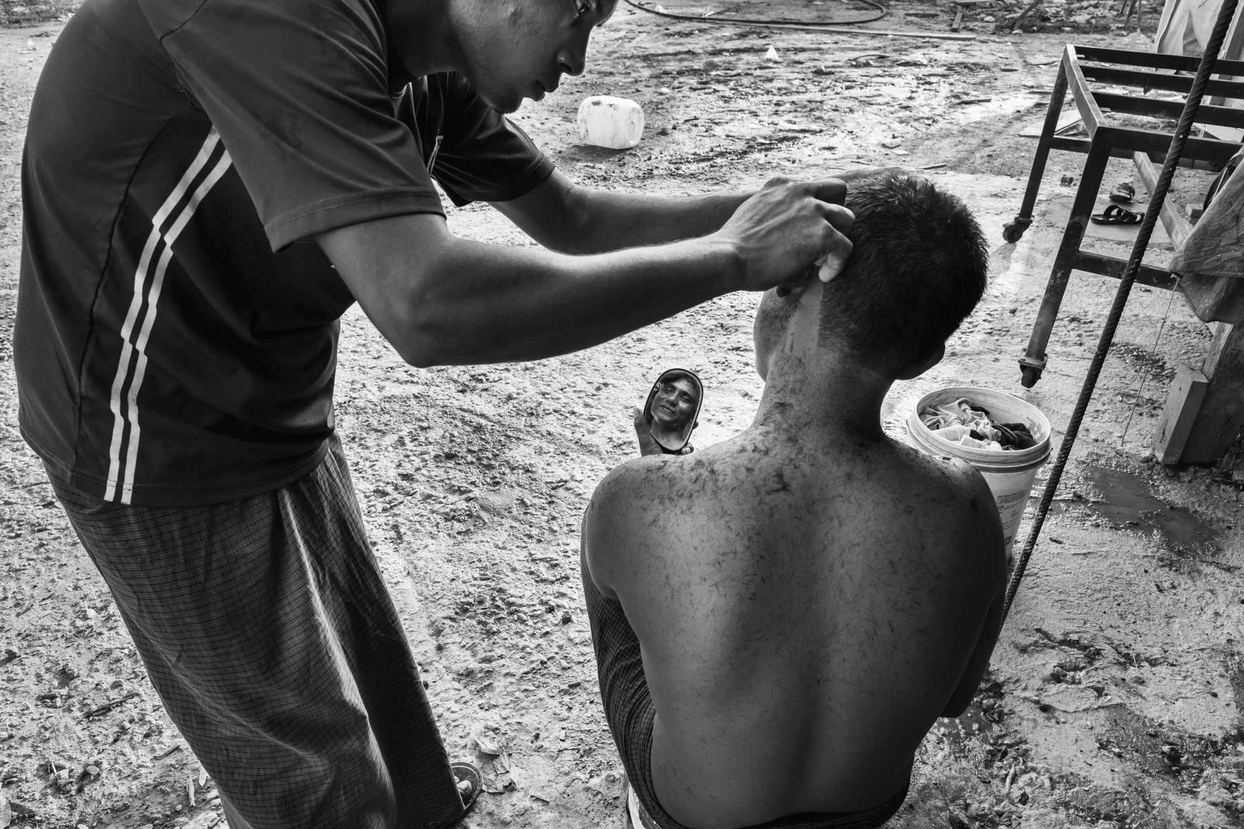 A Rohingya construction worker getting a hair cut during his day off. MBI construction site, one of the largest contruction projects in Northern Malaysia and employing around 1,200 un-registered Rohingya, Desa Ku in Kedai, Malaysia, June 2017