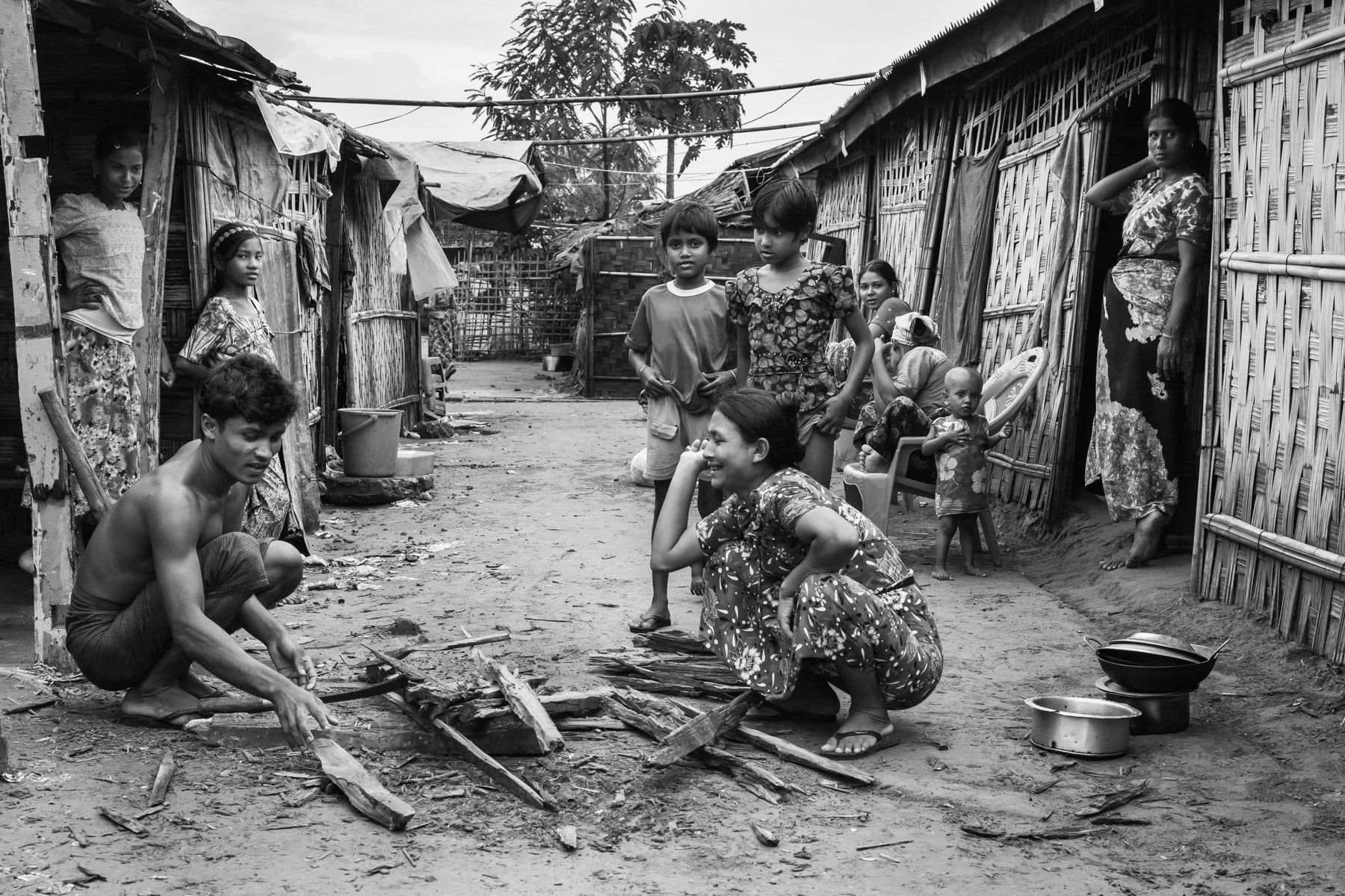 Preparing fire wood for cooking. Dar Paing internment camp, Sittwe township, Myanmar, October 2016