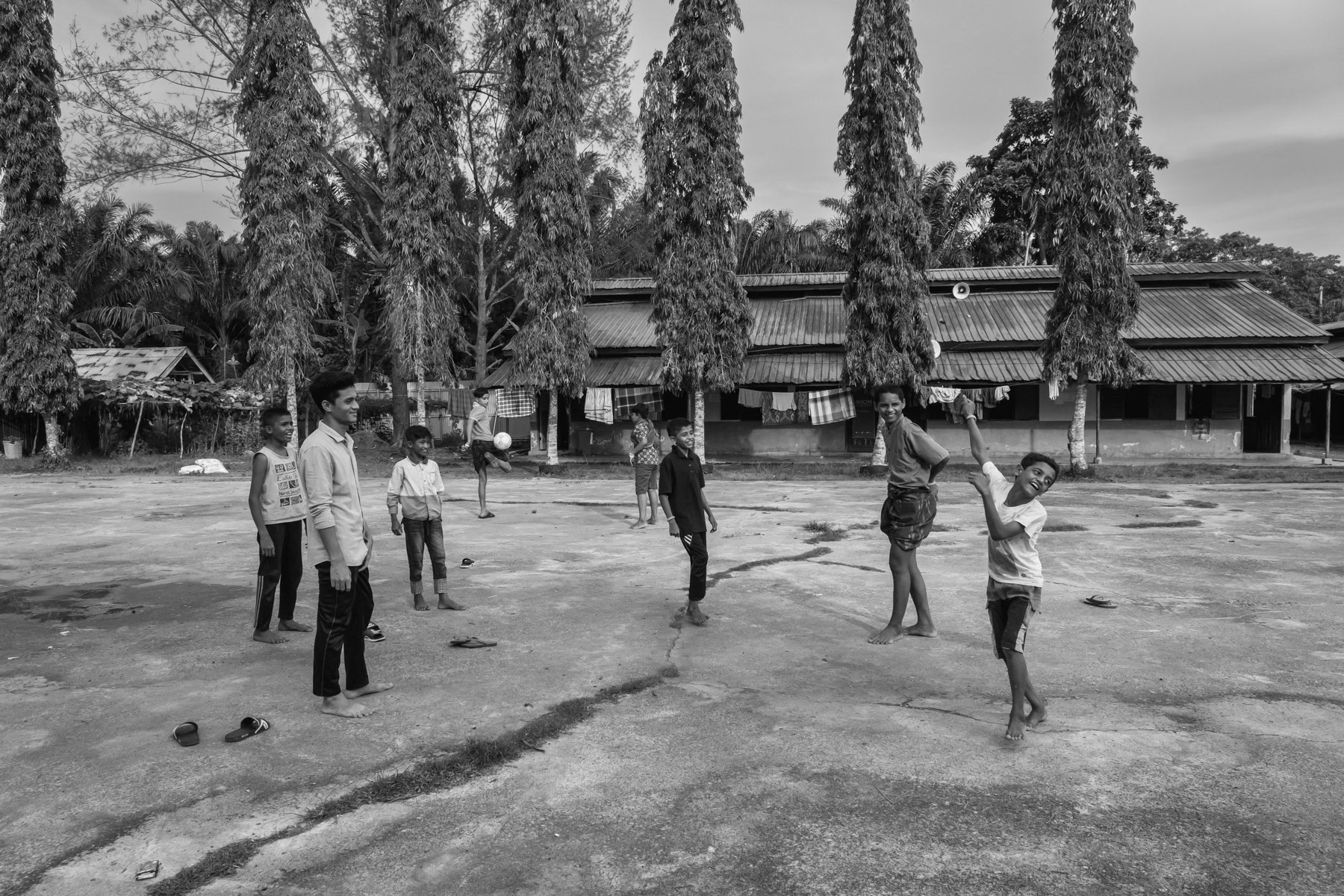 Rohingya children playing and now living in barracks where they are held since they arrived on the shores of Aceh after a sea crossing from Myanmar and Bangladesh. All had to pay high amounts to traffickers to make the perilous journey and escape persecuation. Padang Pijie, Sumatra, Indonesia, October 2023