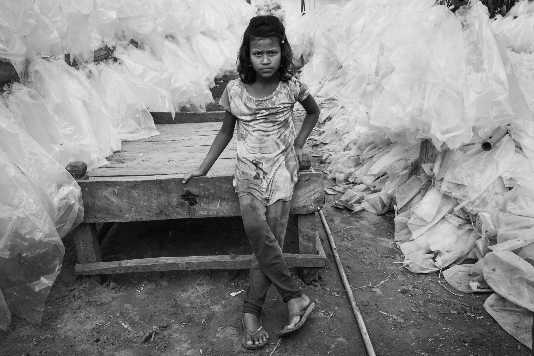 Rohingya girl working occasionaly at the fish drying areas near Cox's Bazar where numerous Rohingya refugees can find low paid jobs. Najirar Tak, Cox's Bazar, Bangladesh, March 2018