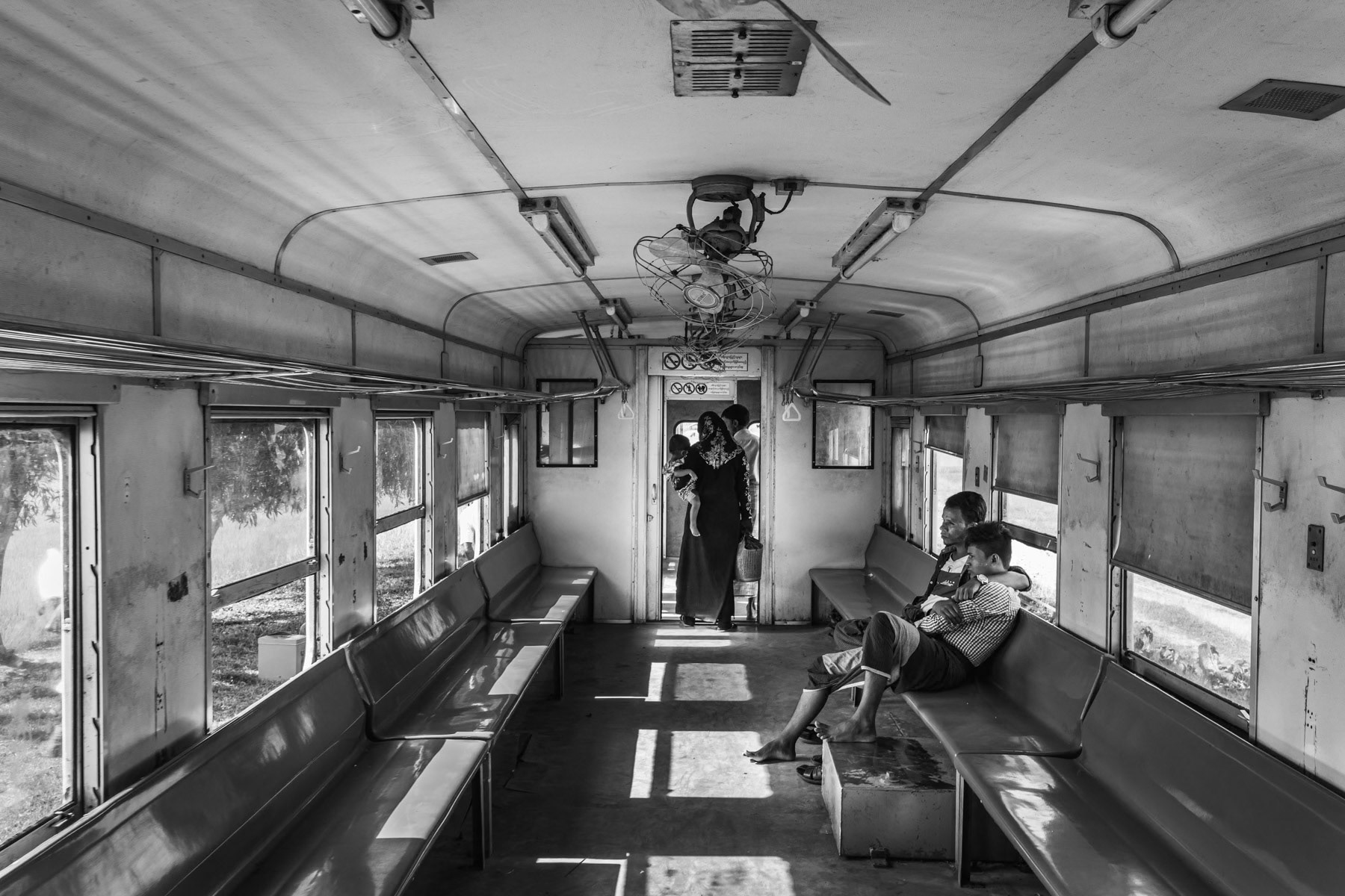 Rohingya minority travelling on the local train between the IDP camps. They are not allowed to travel to Sittwe and the trains are guarded by heavily armed police forces. Sittwe township, Myanmar, September 2019