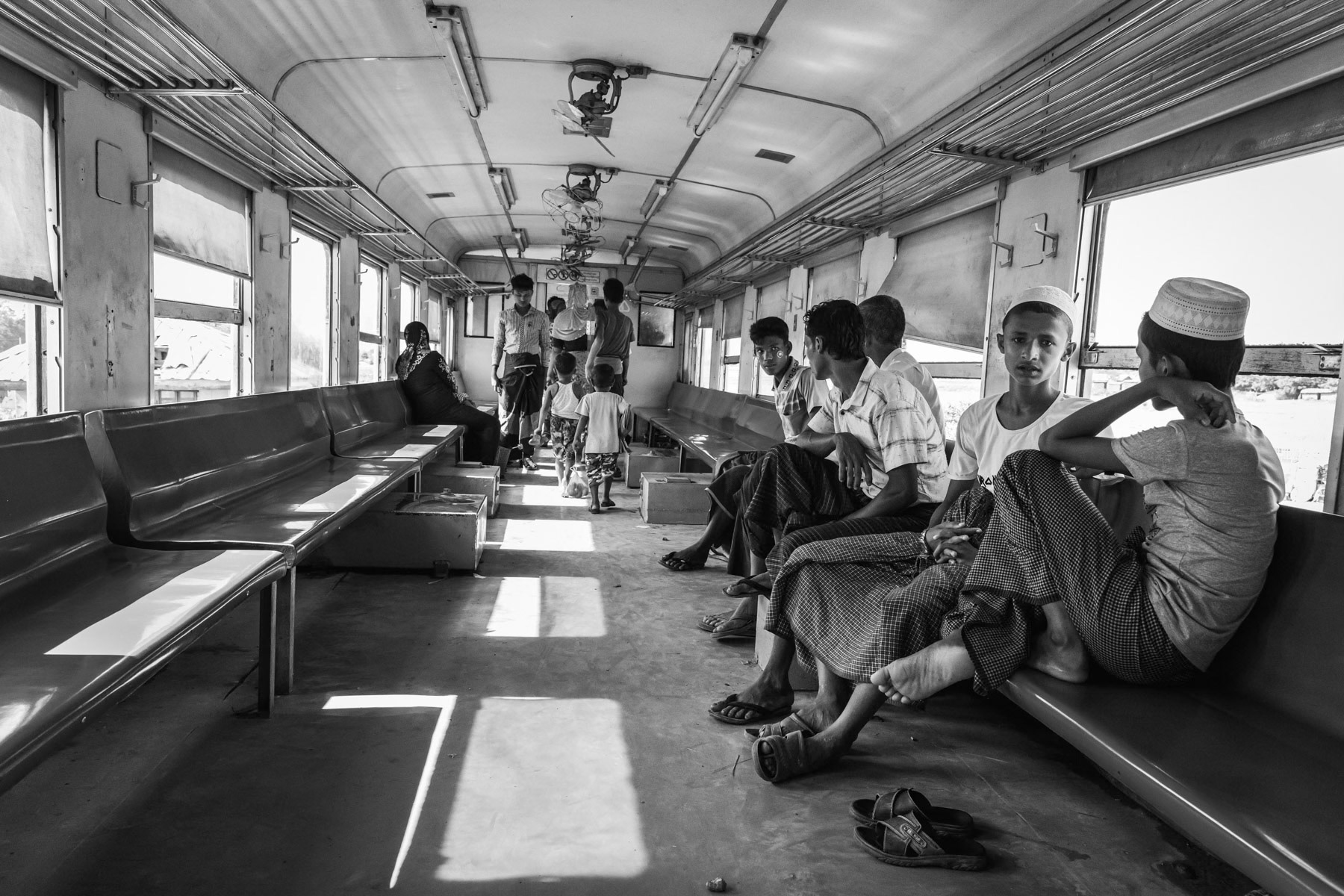 Rohingya minority travelling on the local train between the IDP camps. They are not allowed to travel to Sittwe and the trains are guarded by heavily armed police forces. Sittwe township, Myanmar, September 2019