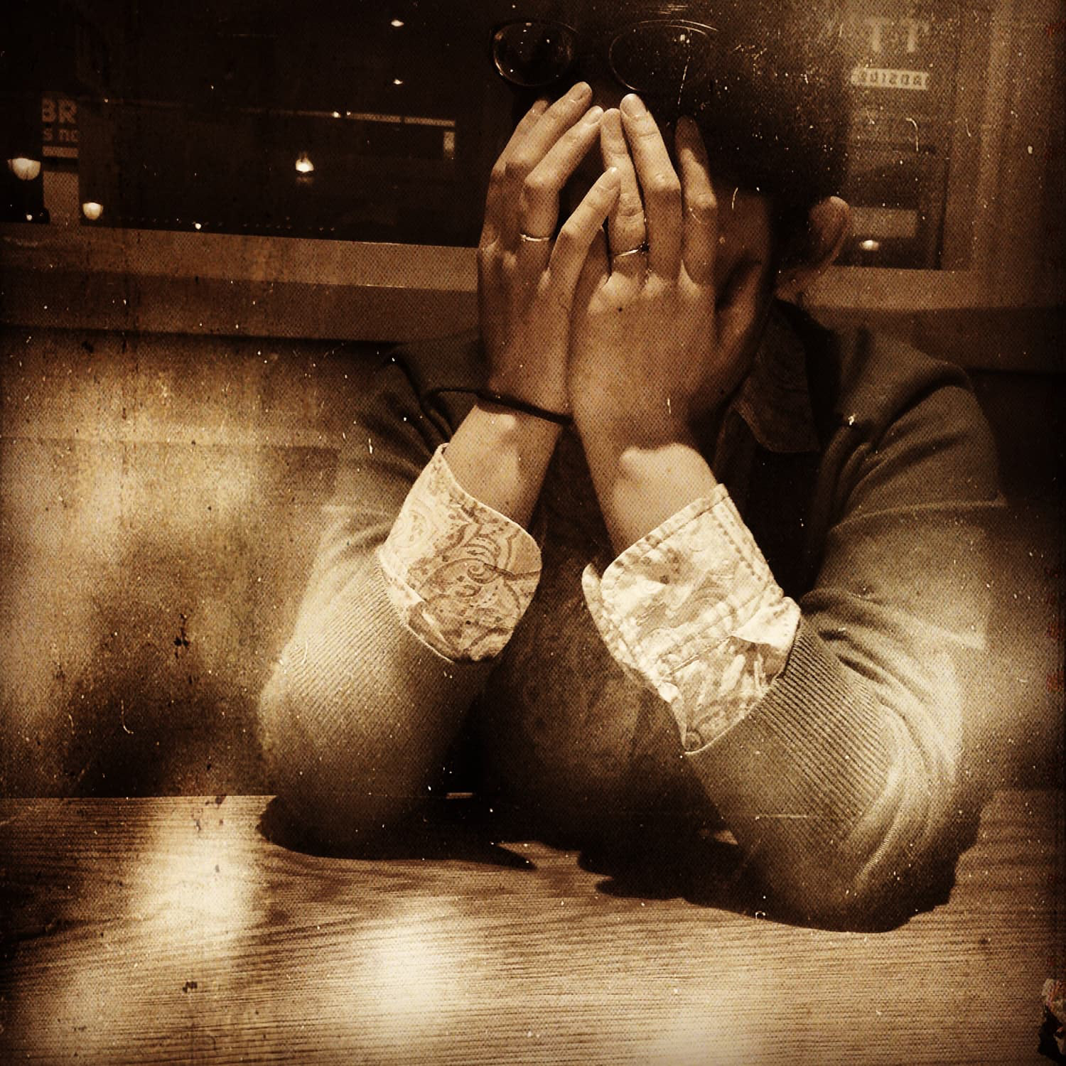 Girl with hands in front of face