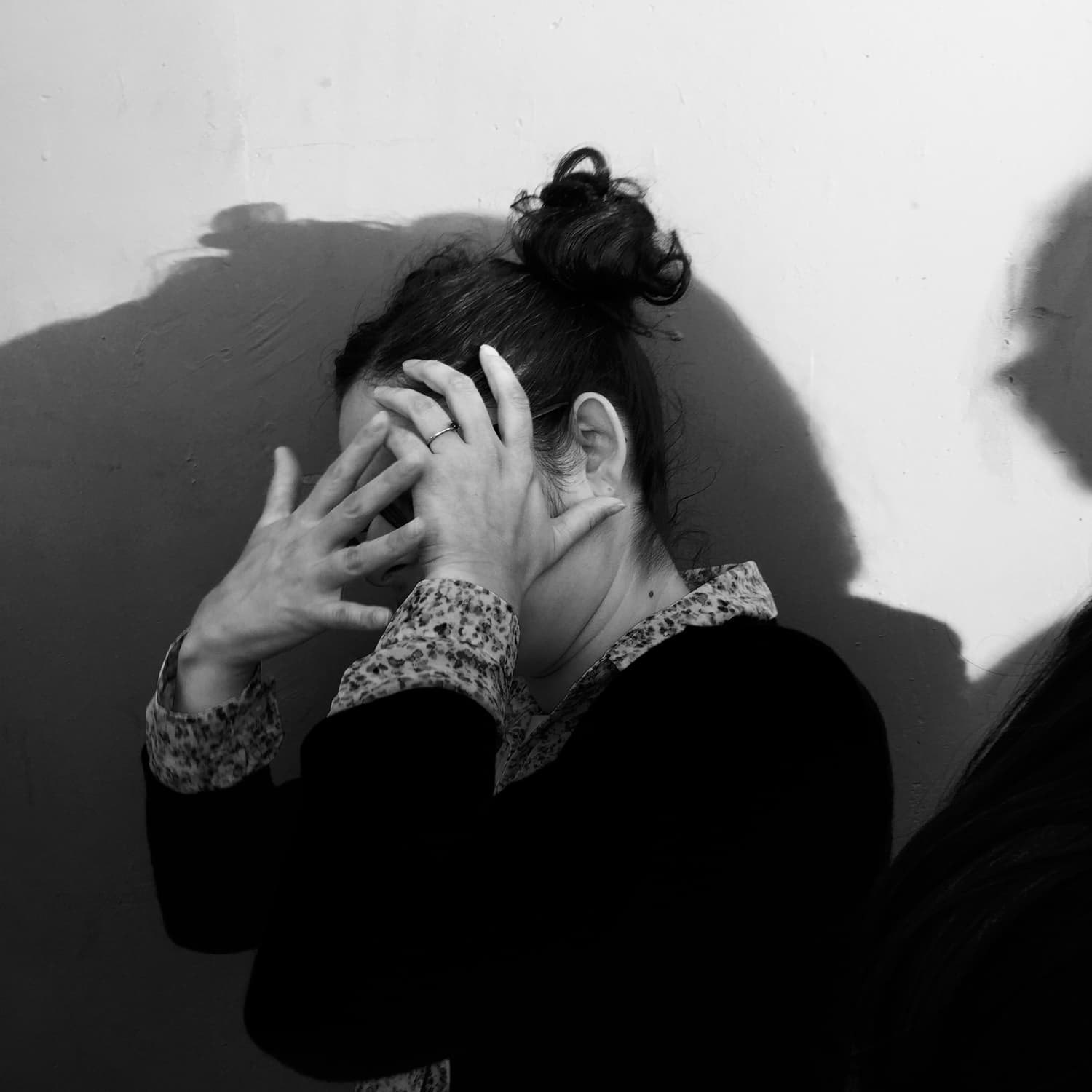 Girl with hands in front of face