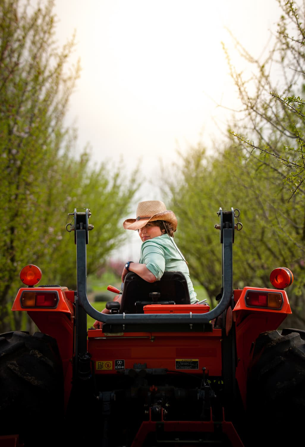 Tina Reikes on tractor Bear Flag Farm Winters, California