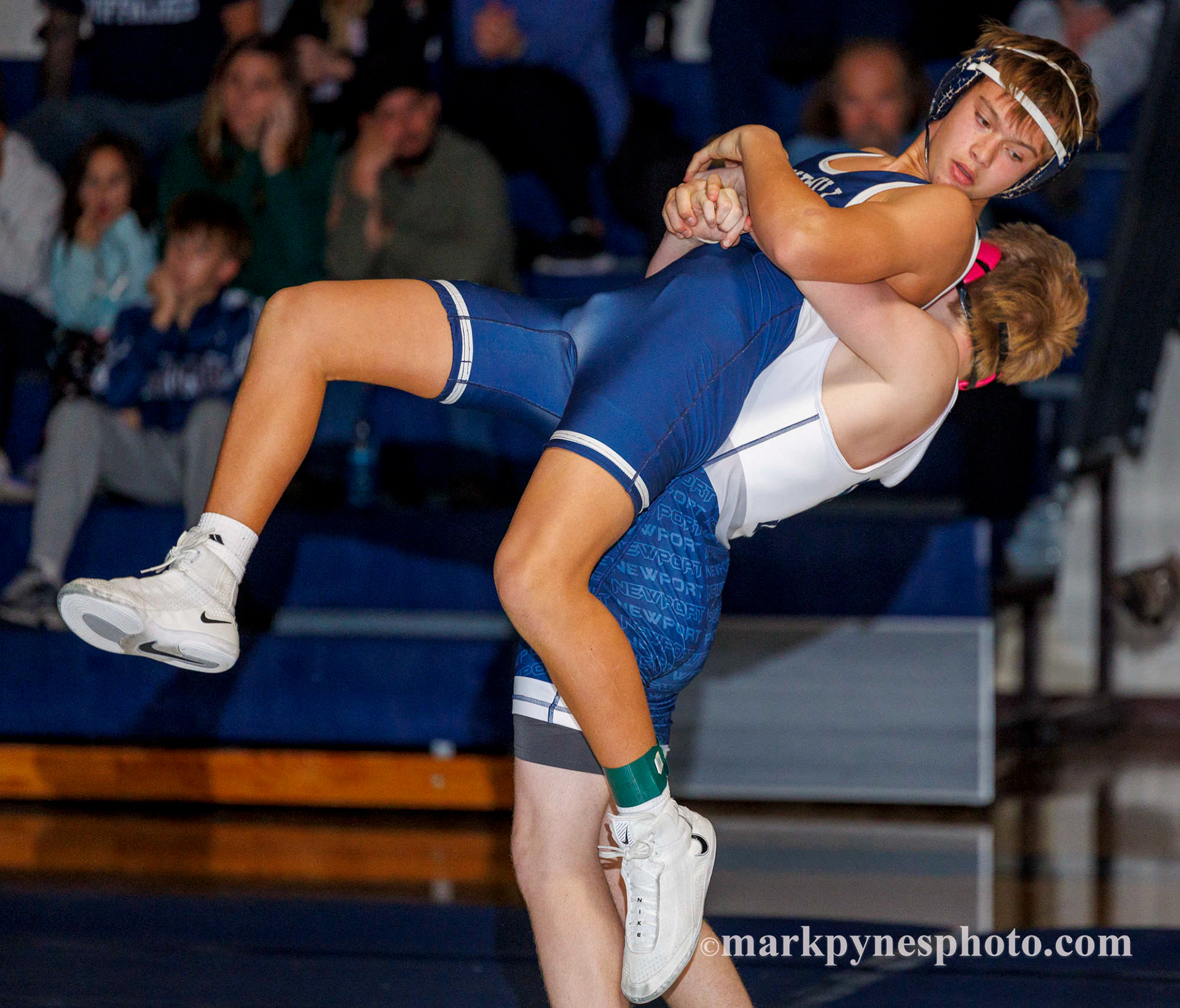 Newport’s Blake Blumenschein lifts Camp Hill’s Rowan Howard in a 152 pound exhibition match.