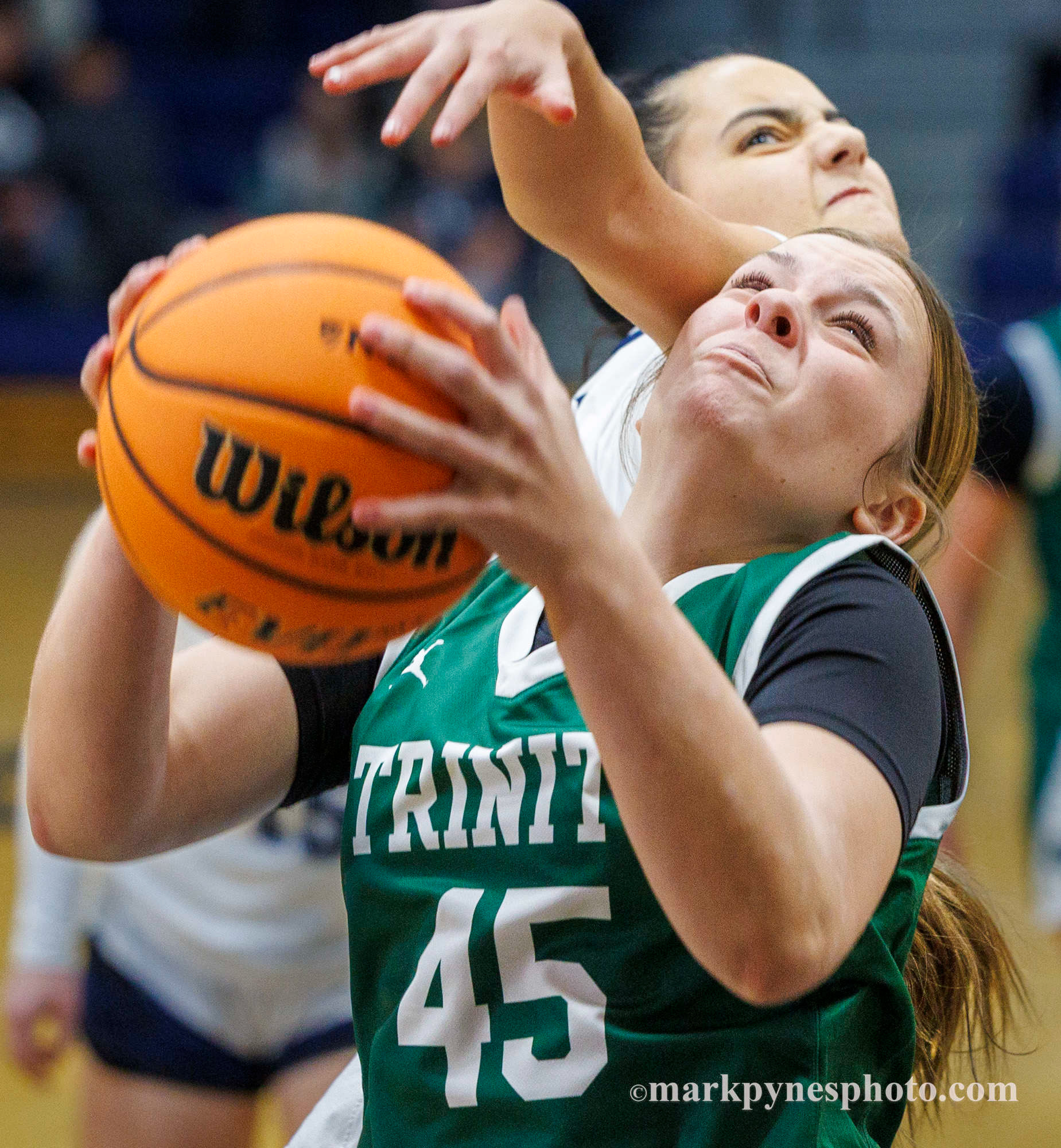 Cecilia Benavides, Camp Hill, blocks Trinity’s Lillian Kertis, but Trinity wins, 61-16.